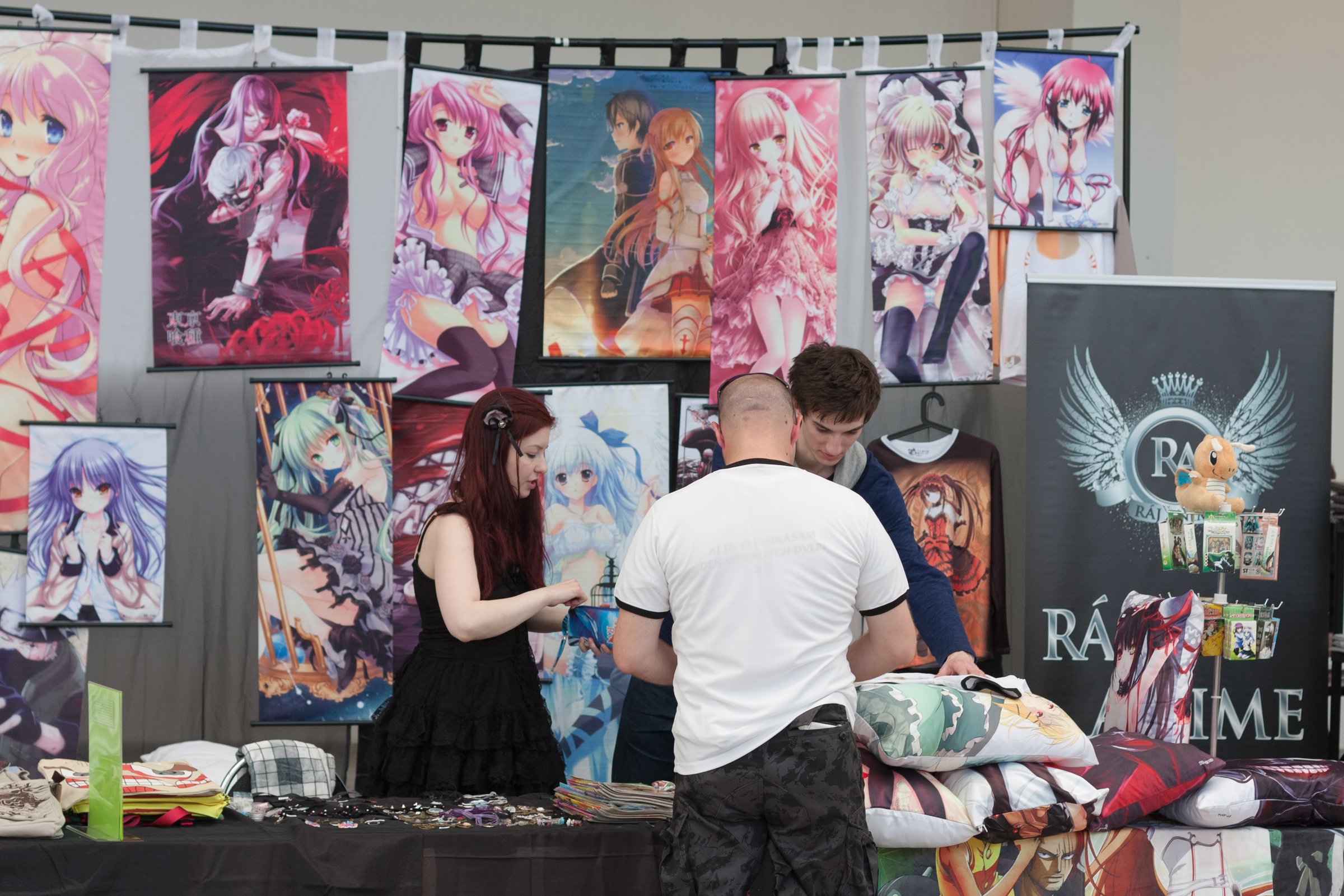 Brno, Czech Republic - April 30, 2016:Visitor of animefest buys at market with anime wall scroll at Animefest, anime convention on April 30, 2016 Brno, Czech Republic