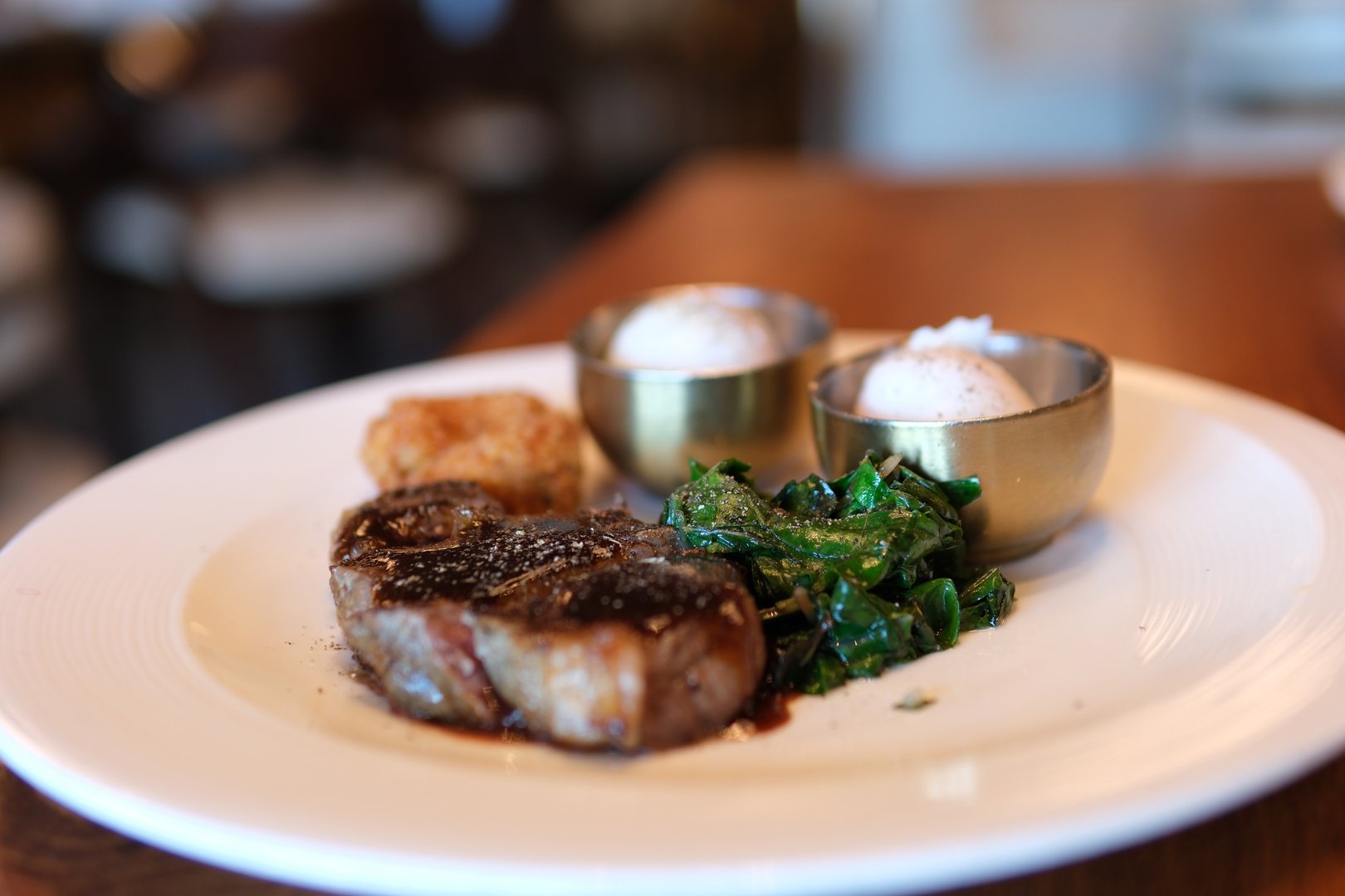 Freshly grilled pieces of beef steak meat on a fork rotating on a black background. Close-up of food. medium rare steak