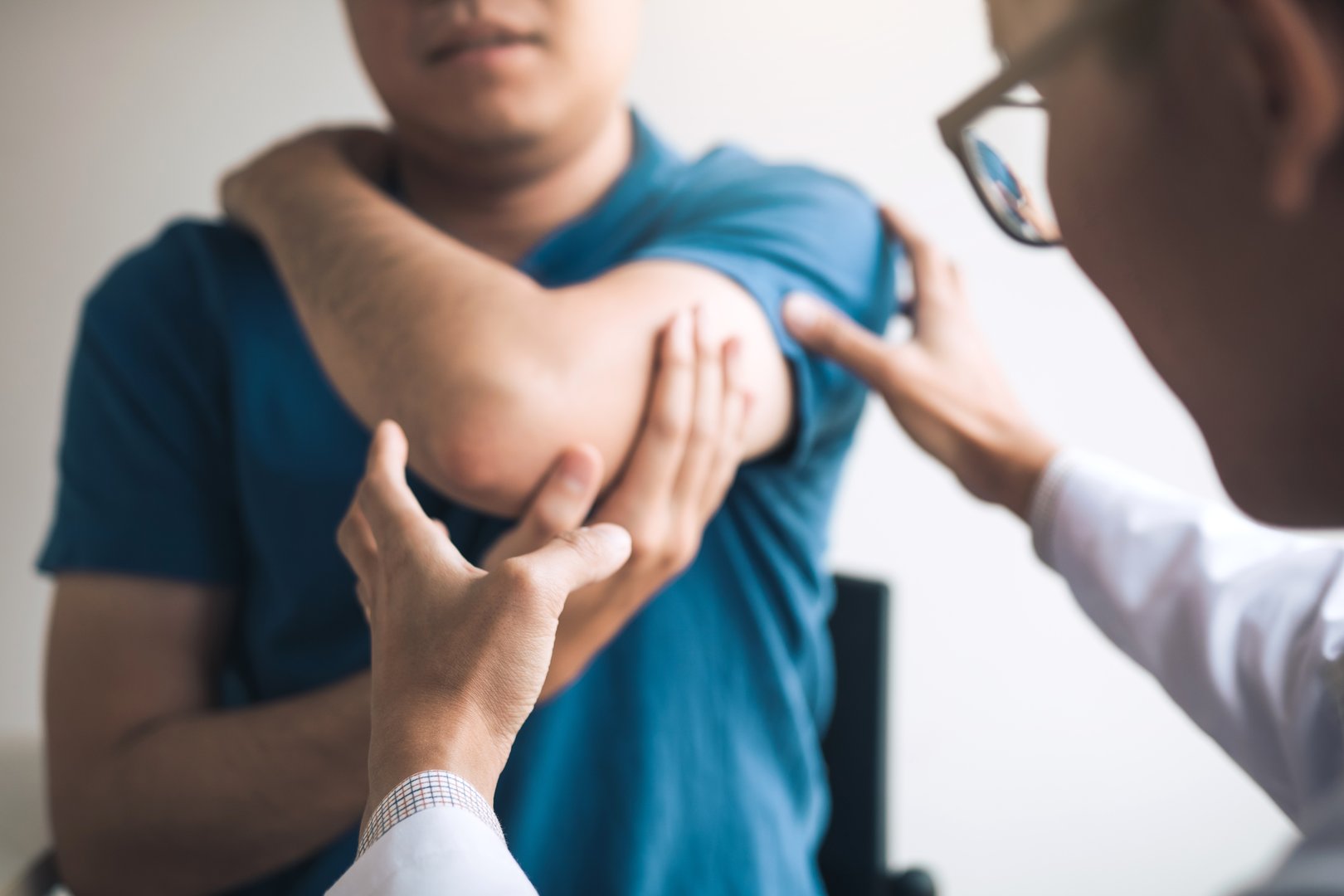 Doctor performing elbow examination