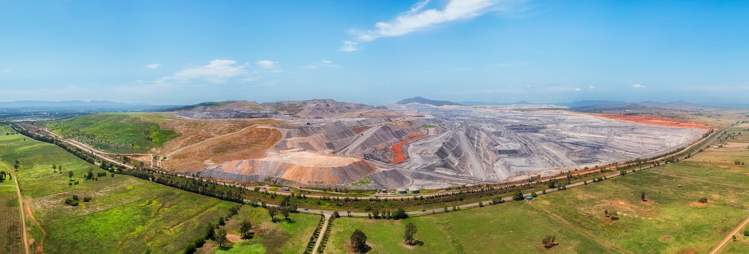 Massive Mount Arthur open pit black coal mine in Hunter valley of Australia - green scenic aerial panorama.