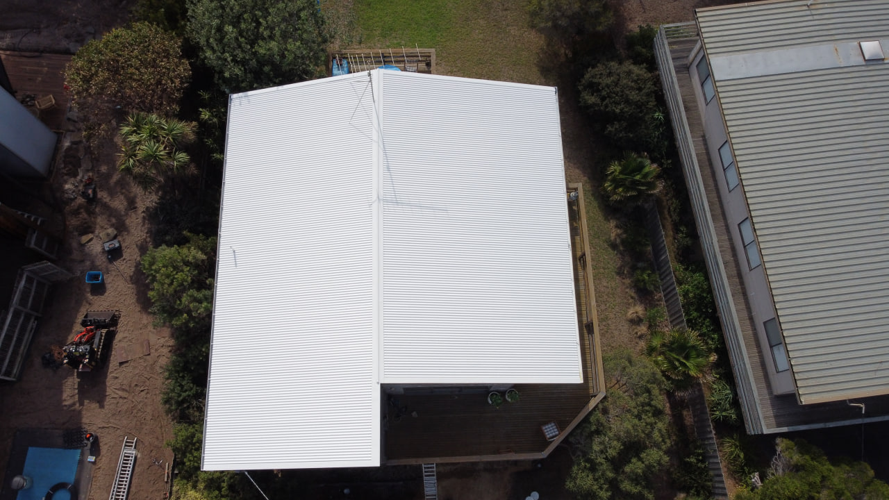 After roof painting - freshly painted metal roof with protective coating applied