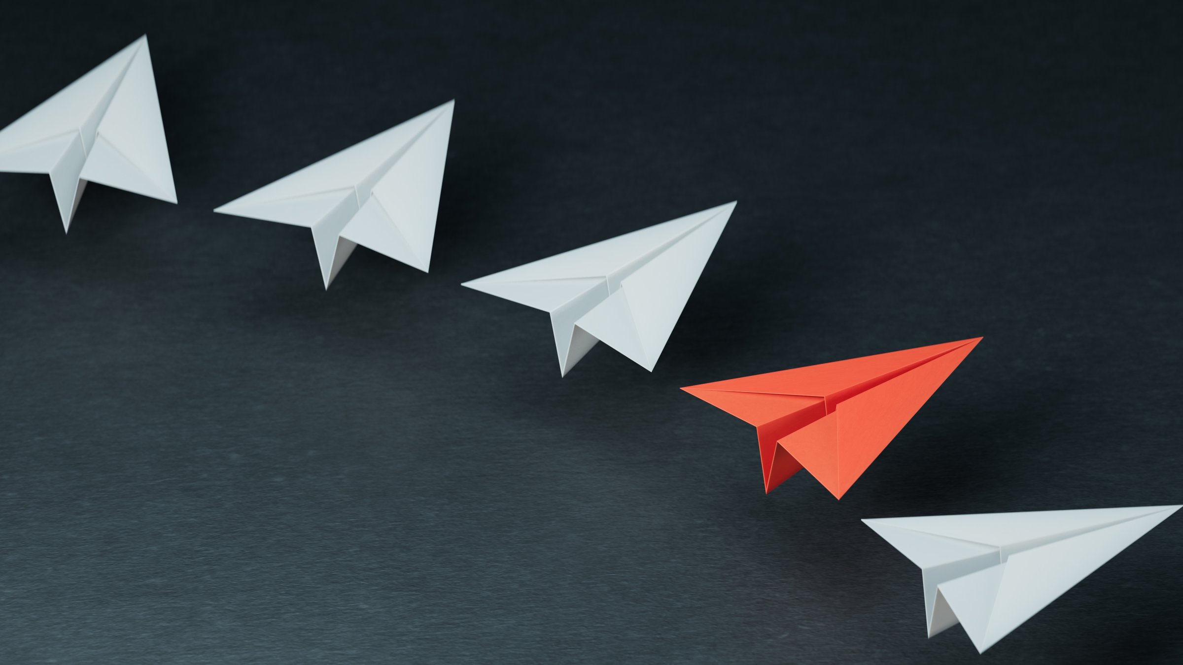 Different business concept.new ideas. paper art style. creative idea.fleet of origami paper planes. Teamwork concept.3D rendering on black background.