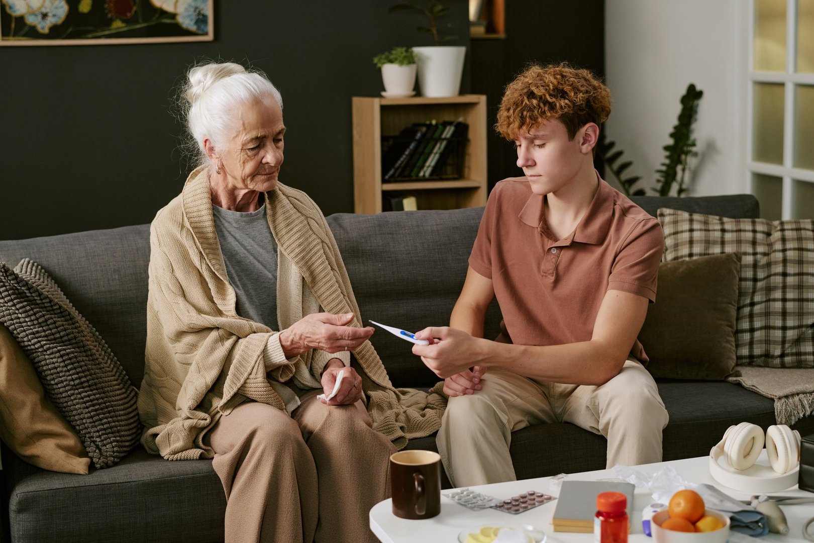 Senior woman receiving care from family member at home
