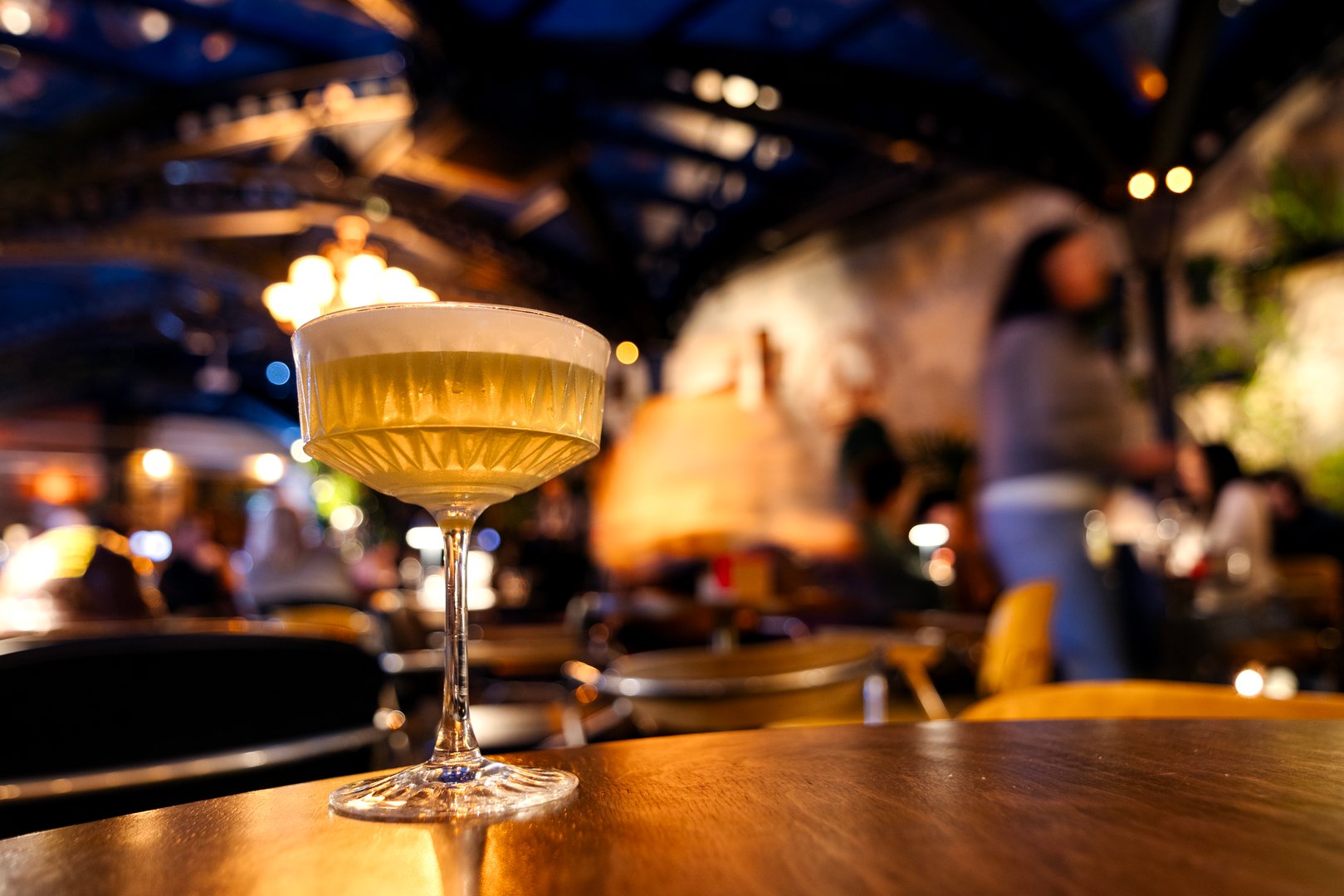 An alcoholic cocktail in a glass on a thin high stem