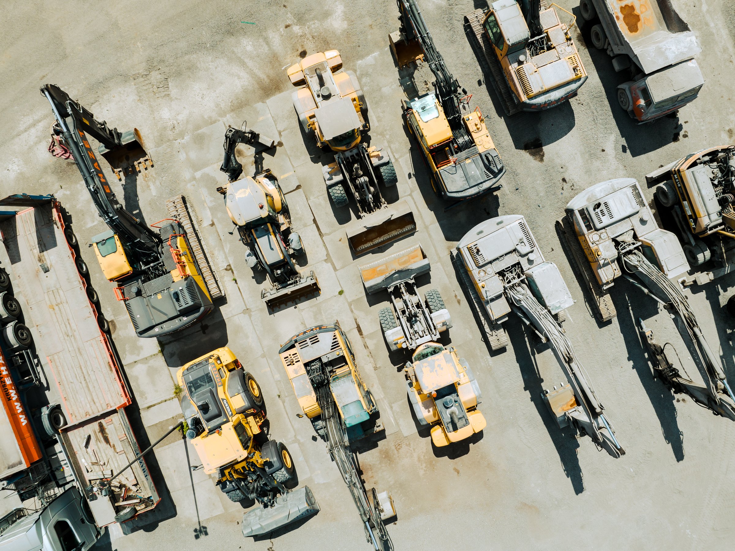 Aerial View of Industrial Equipment and Excavator on Industrial Place. Construction site top view. Shooting from the drone.
