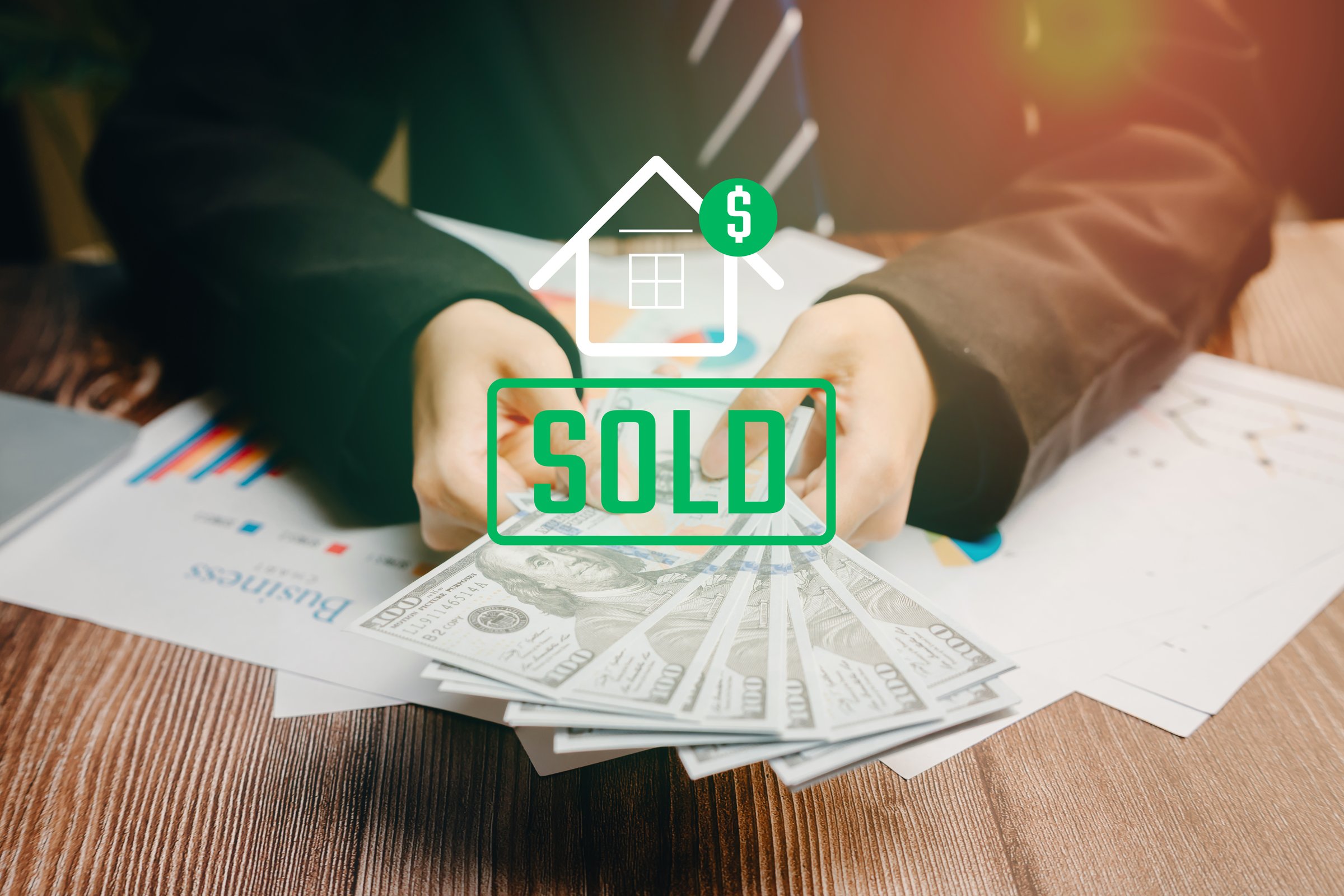 Sold concept. Business Transaction with Cash and Sold Sign for Real Estate Investment and Financial Success.