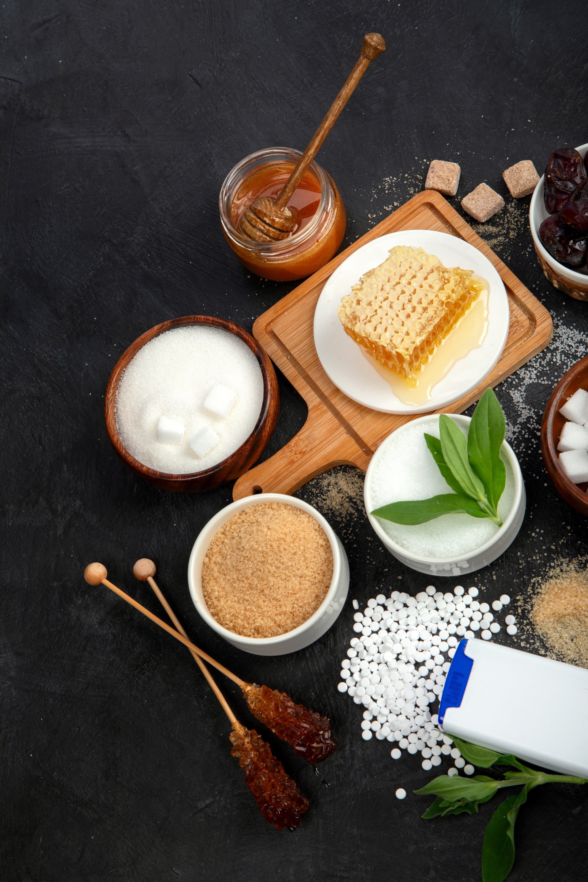 Various diet replacement for sugar on dark background. Organic sweetener concept. Top view, flat lay, copy space