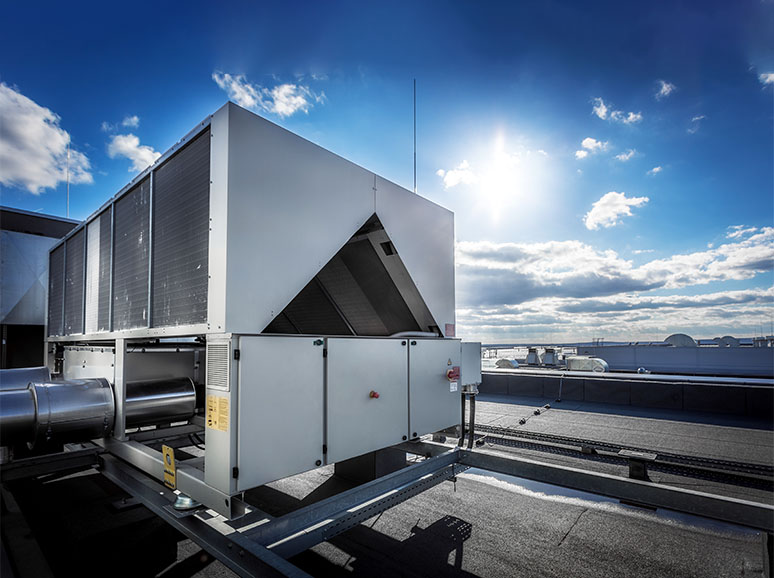 Diverse group of workers install air conditioner in commercial building.