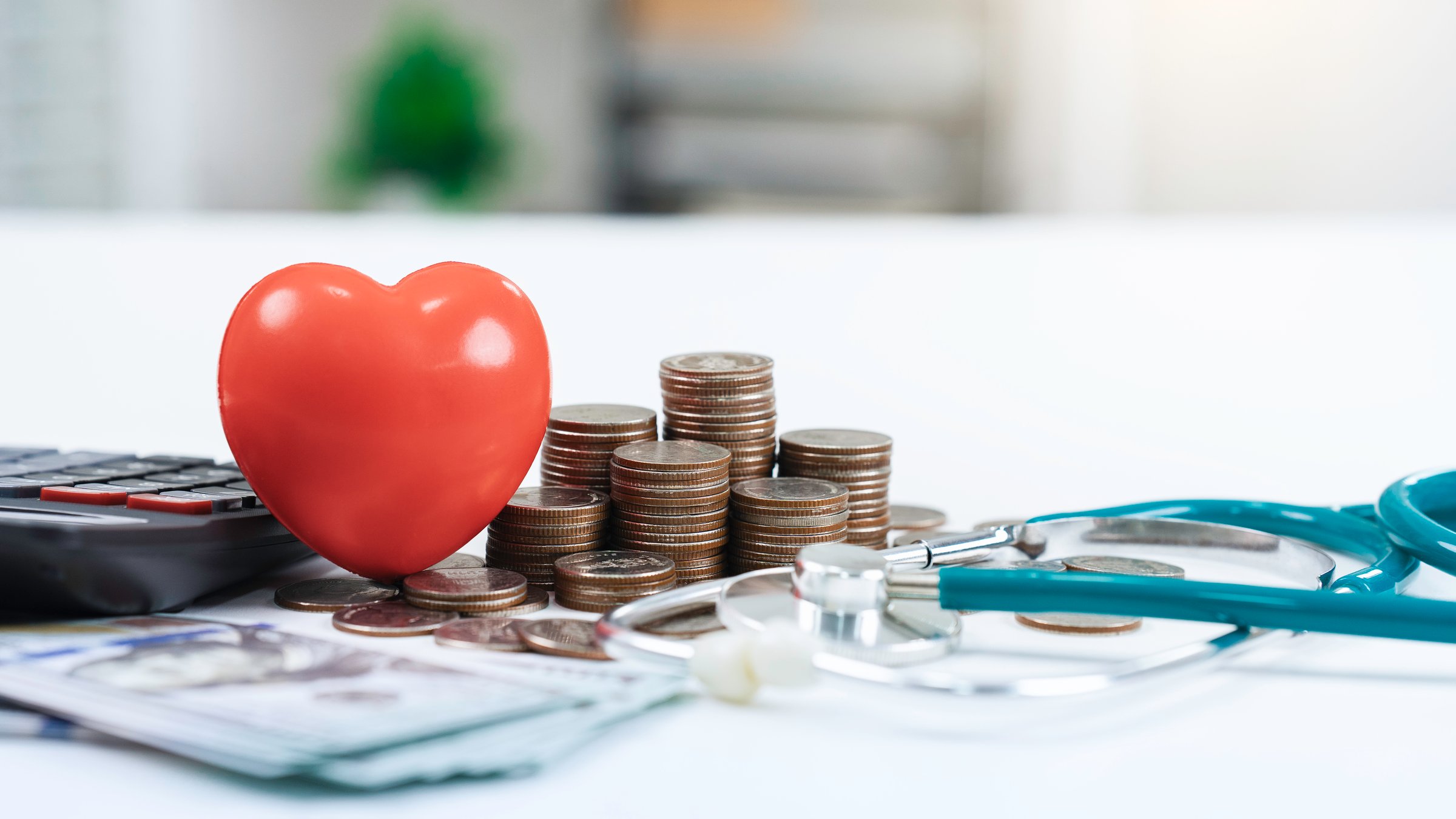 Health care insurance for medical expense concept. stethoscope and money with red heart in hospital. financial management and planning for cost in future. finance and investment in healthcare.