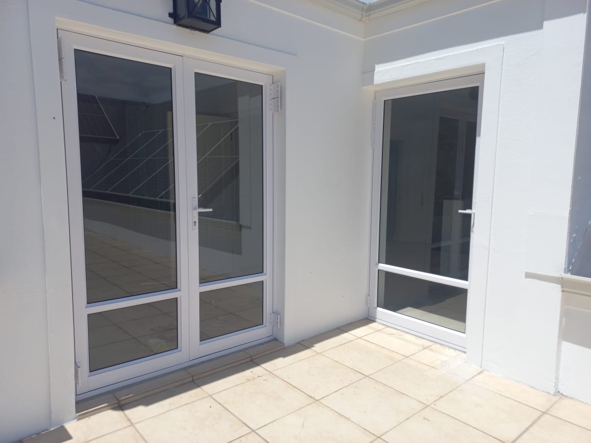 White aluminium hinged door installation