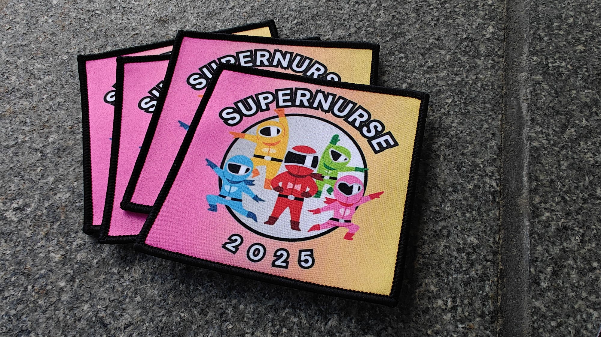 Four colorful fabric patches with Supernurse 2025 design, featuring cartoon nurse characters in superhero poses.