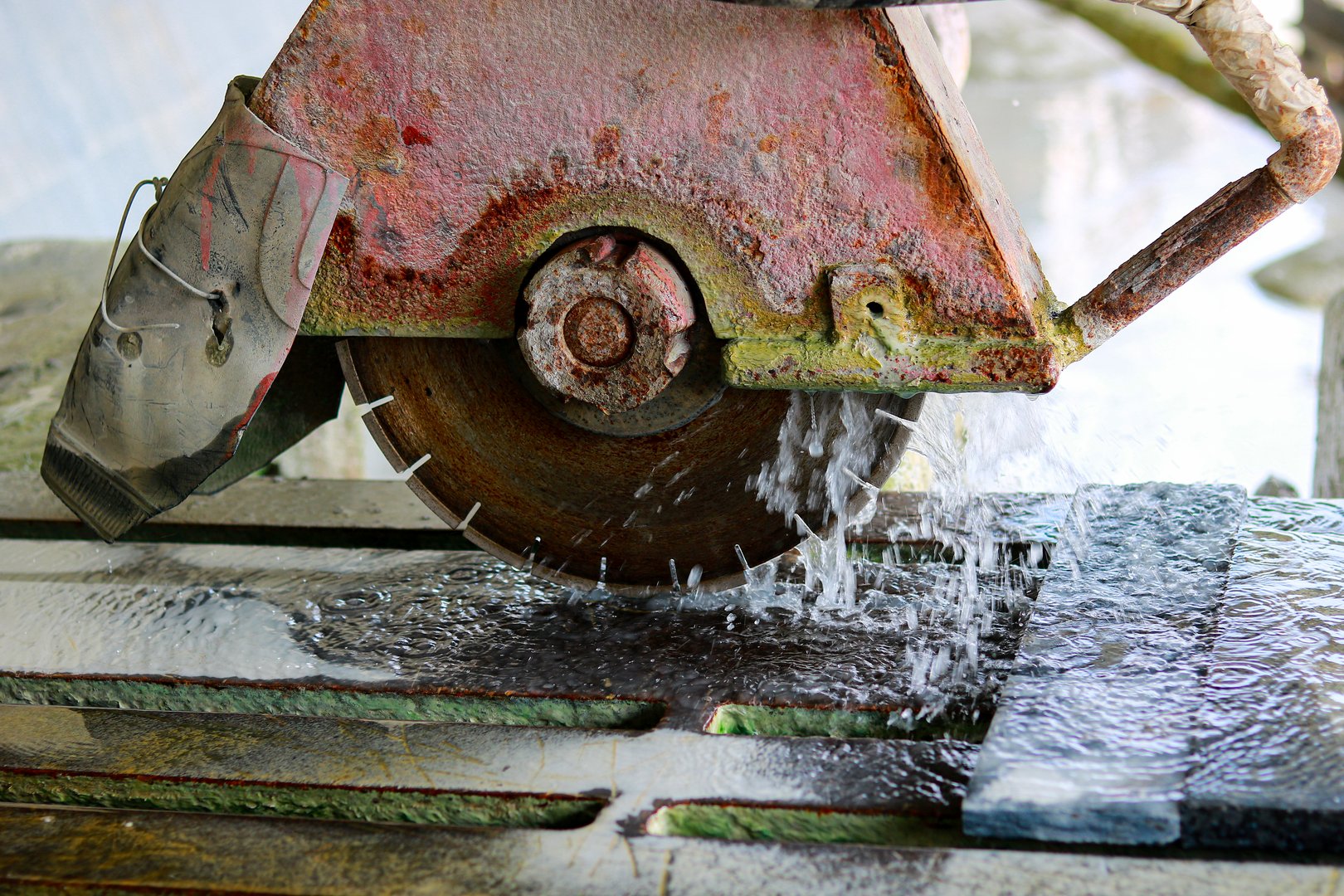 Power saw cutting marble in a factory, closeup of the photo.