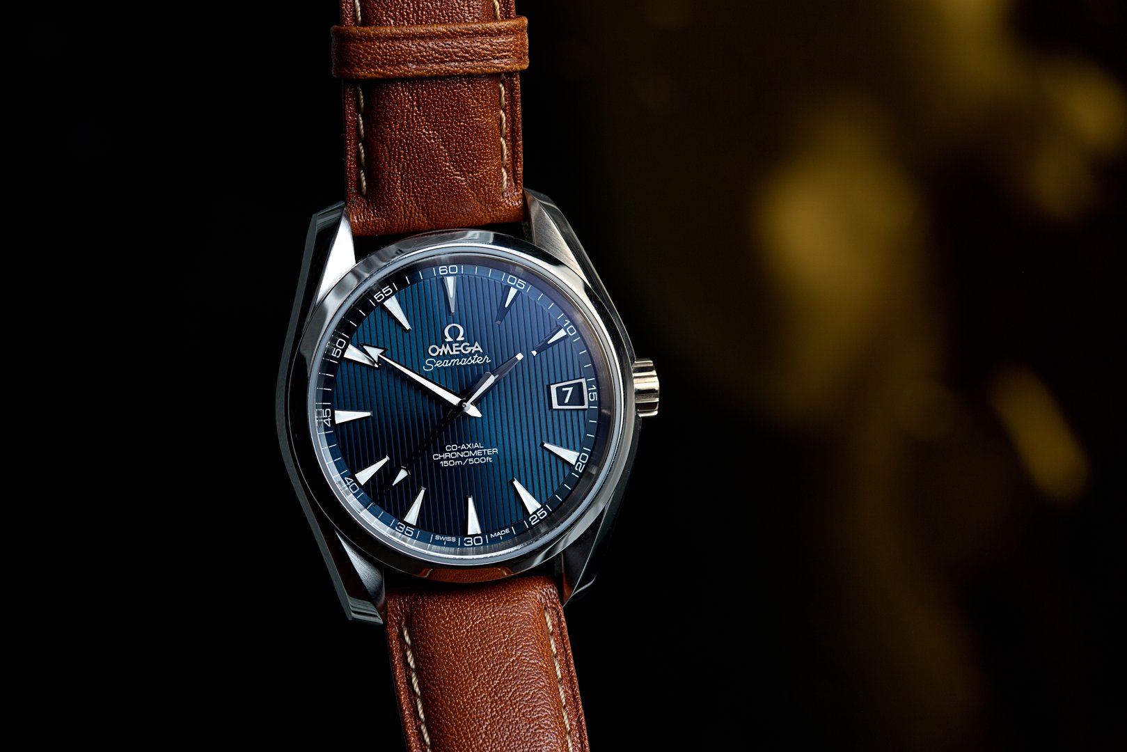 London, UK - November 7, 2015: Omega Seamaster Aqua Terra mechanical swiss watch.  This watch has a blue dial and a light brown camel leather strap.