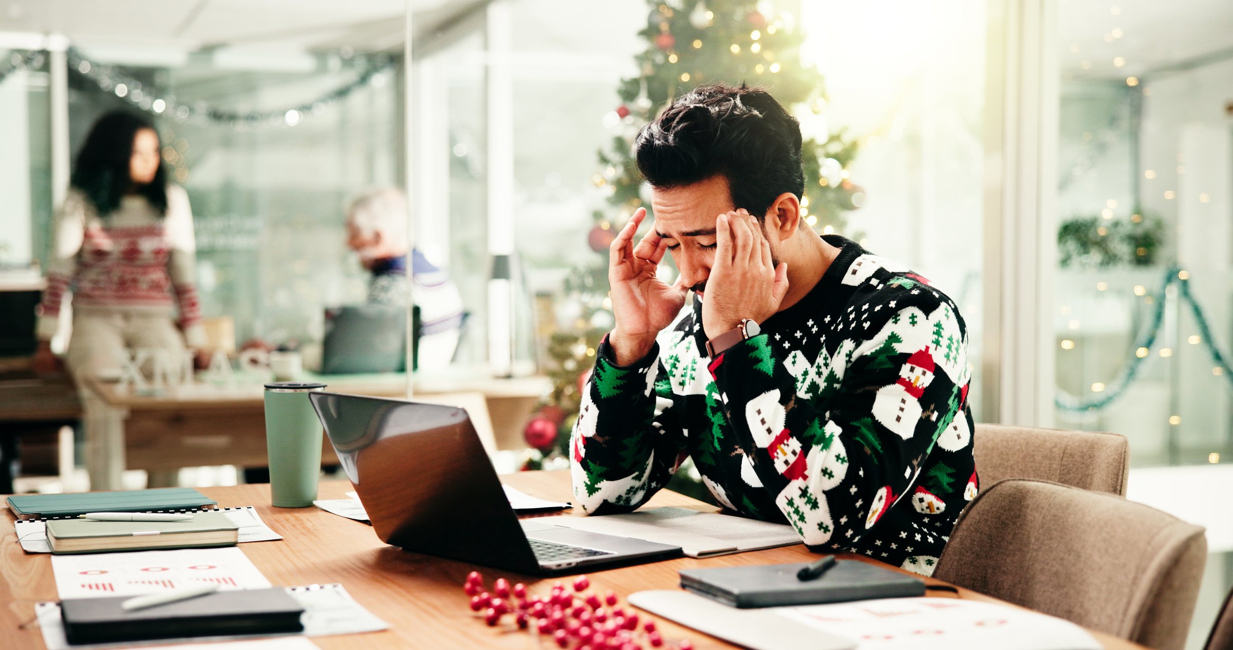Headache, christmas and businessman in office with laptop for stress, burnout or fatigue for workload. Exhaustion, tired and financial advisor with migraine for documents and computer in xmas season.
