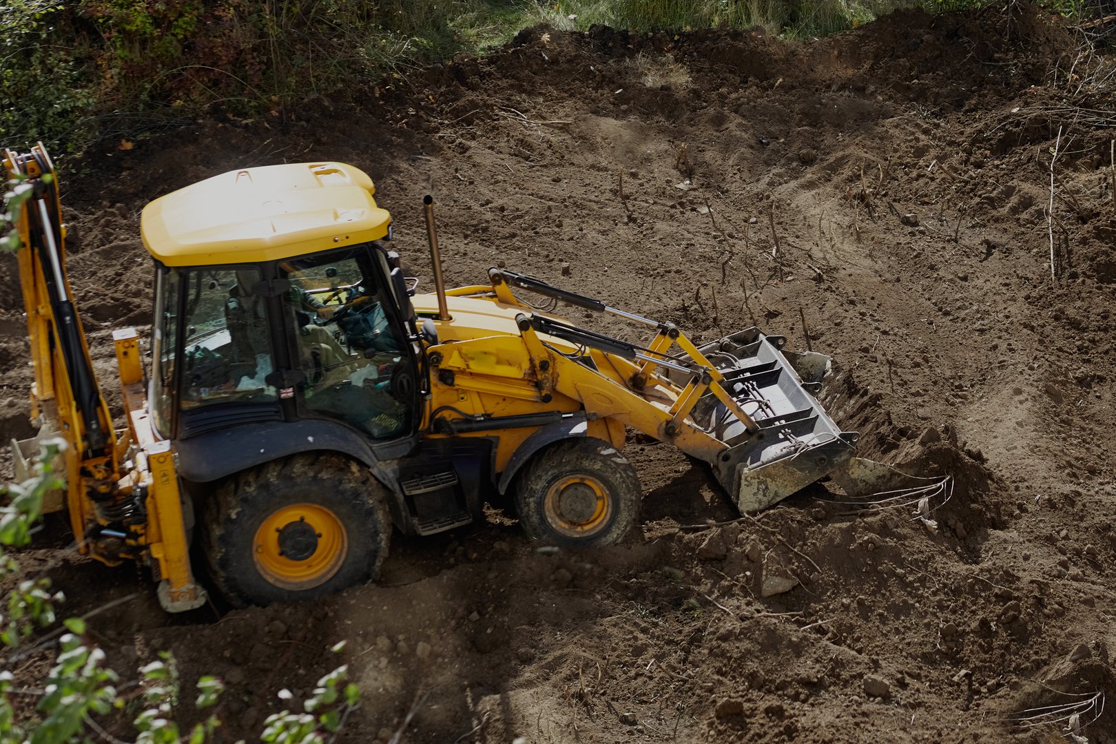 Bulldozer leveling the ground at a construction site, bulldozer work, leveling the ground at the construction site, bulldozer earthworks