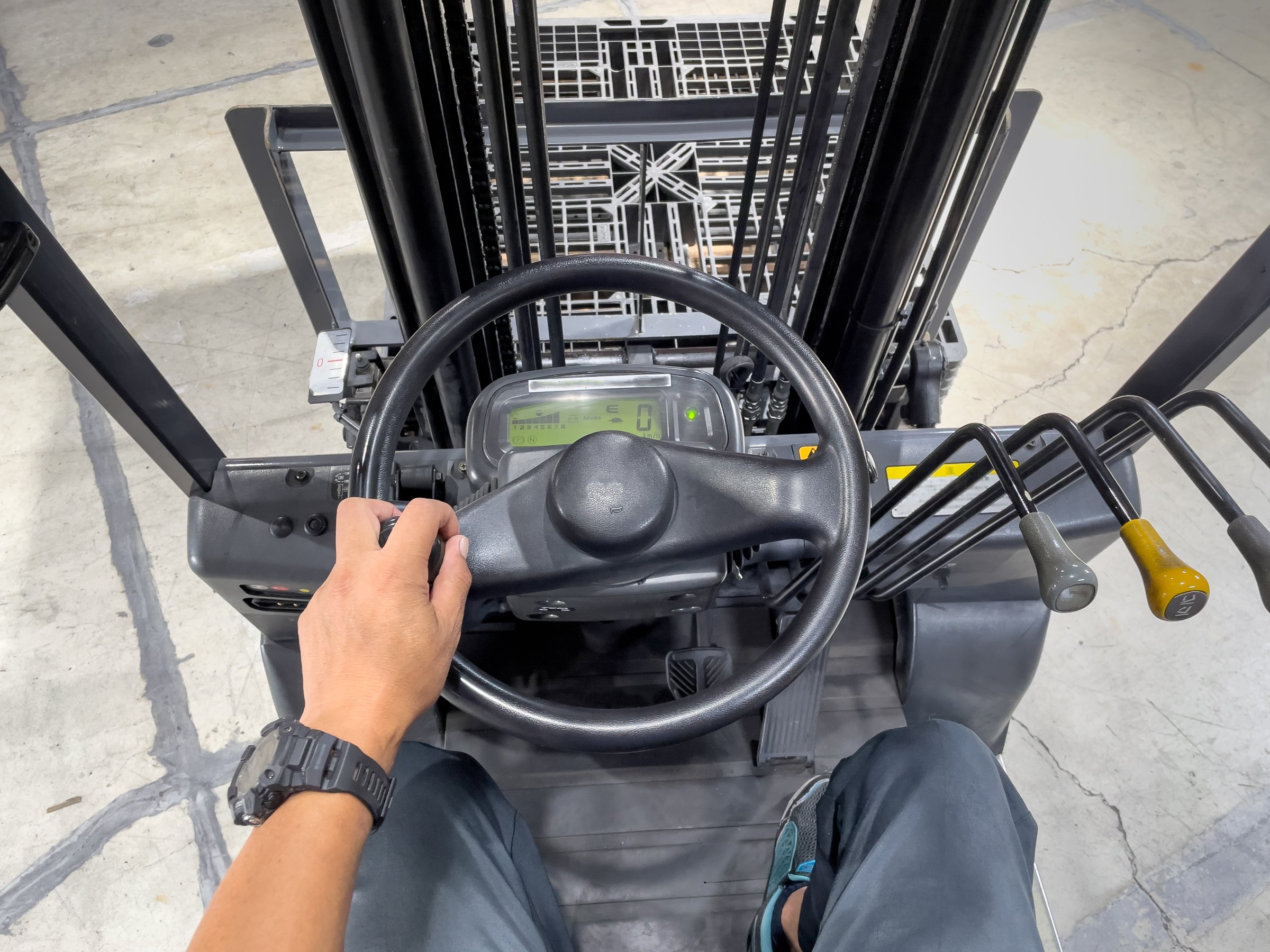 Male hand operating forklift handle