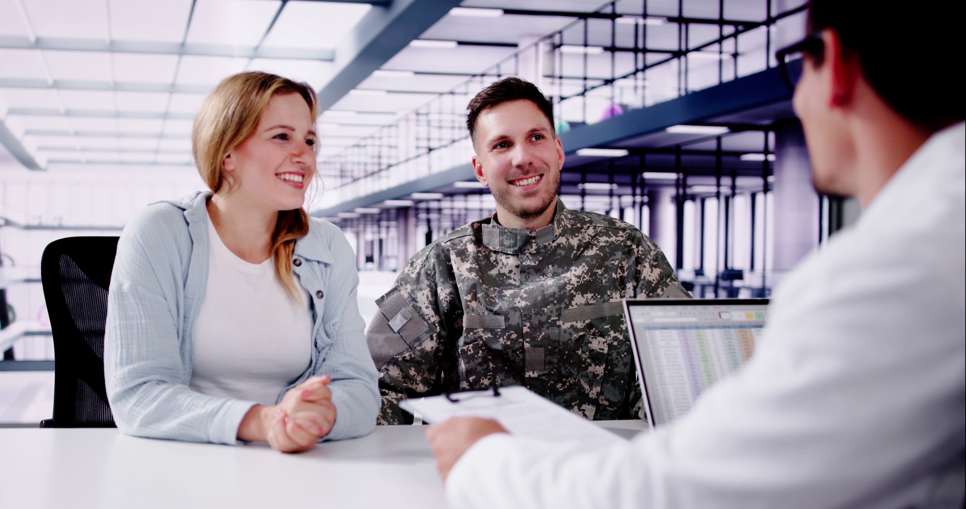 Medical Doctor Providing Support and Counseling to a Young Hispanic Veteran Soldier at a Specialized Soldier Support Clinic.