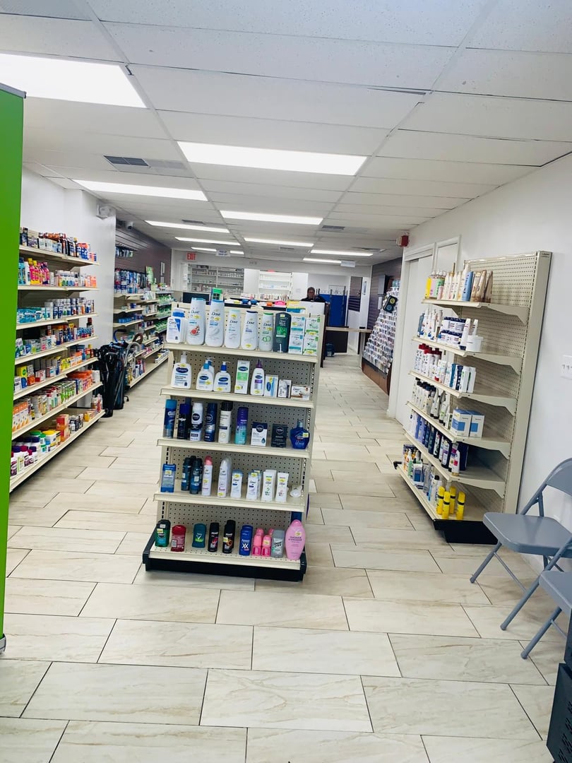 Interior of a pharmacy with shelves stocked with skincare products, toiletries, and medicines under bright ceiling lights.