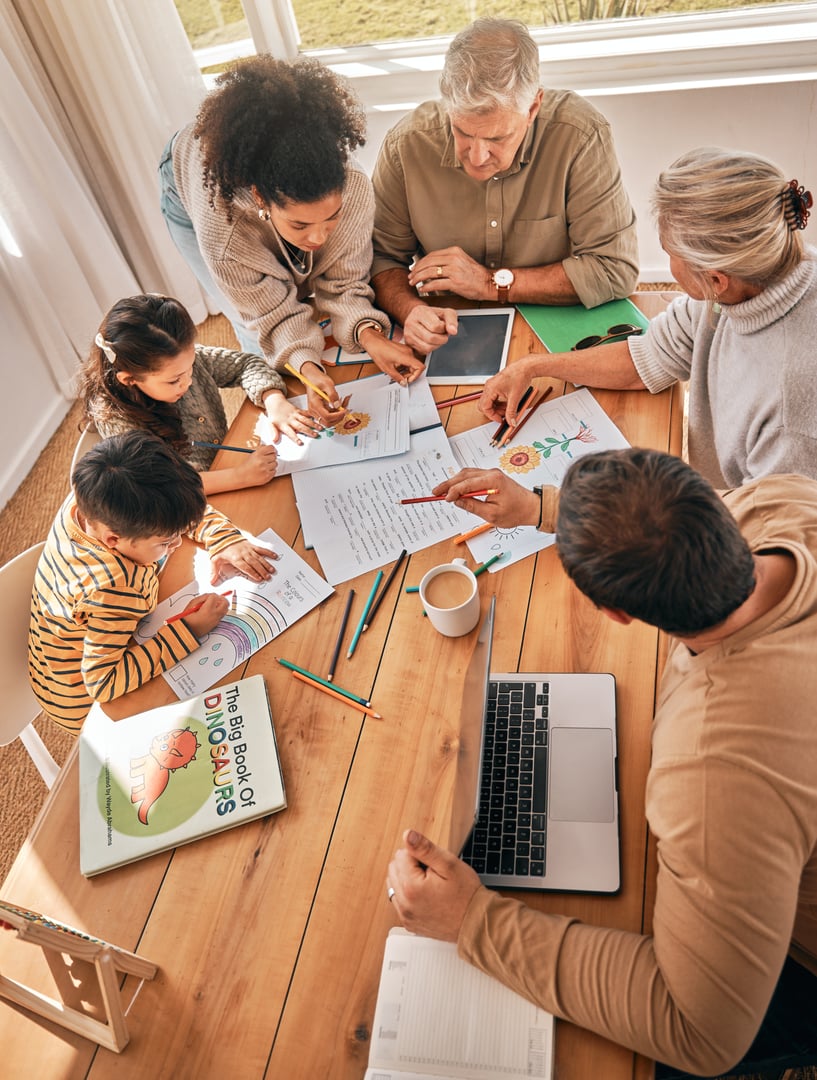 Family home, kids and homework with learning, grandparents and parents with tech in top view. Mother, father and children with laptop, tablet and paperwork in busy house with help, reading or study