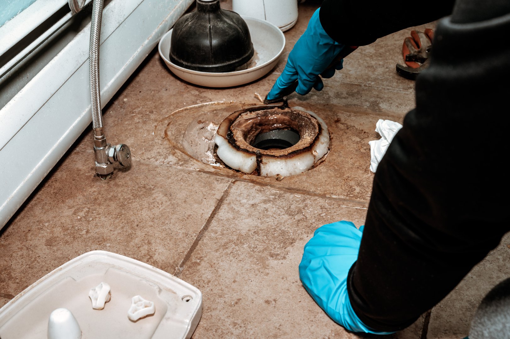 Plumber replacing wax ring
