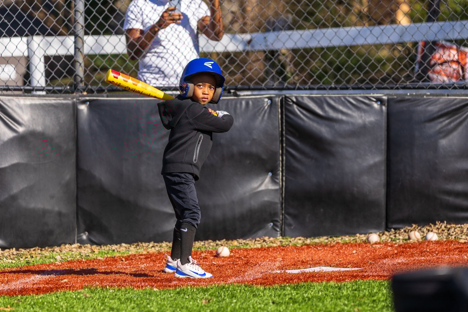 Coach discussing game plan and strategy with young baseball team players on the field