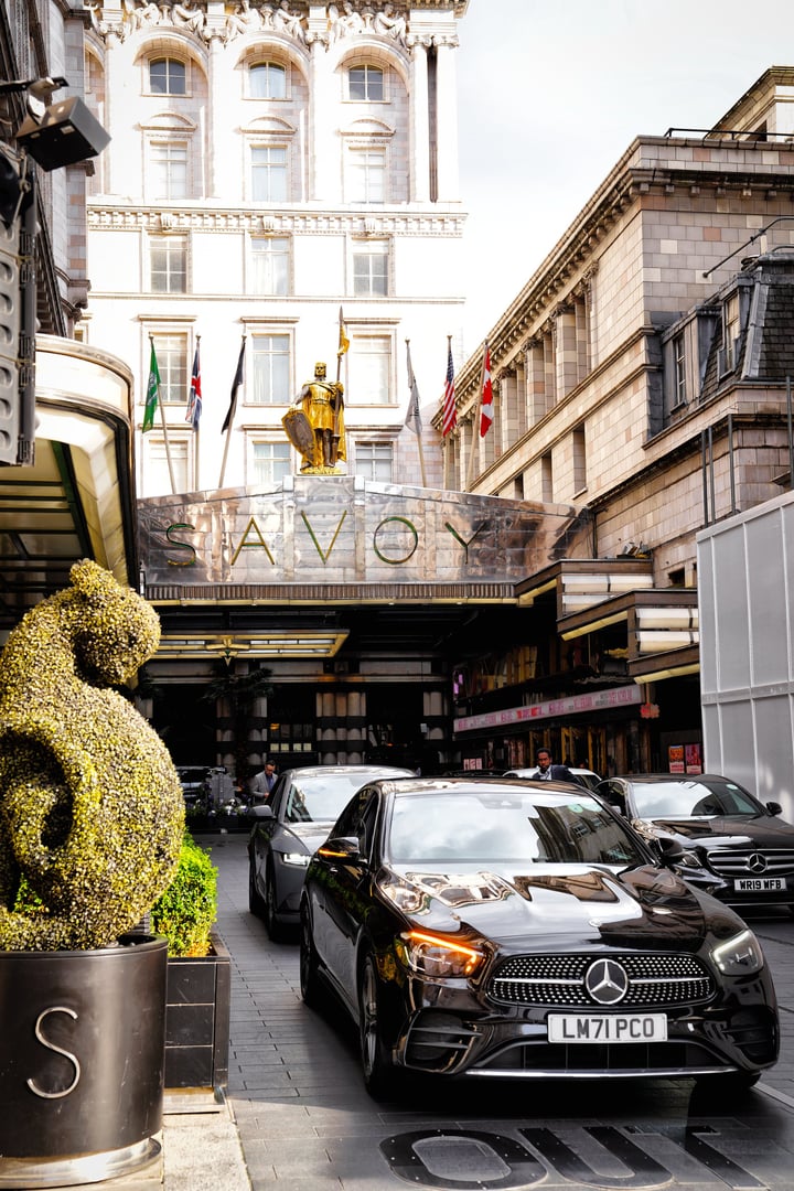 The Strand - the City of Westminster, London, England - July 10, 2024 - a famous street in Central London. a mix of cultural, architectural, and entertainment attractions.the parking facilities at The Savoy: guests arriving in luxury cars or taxis Savoy Hotel, Strand, London WC2.