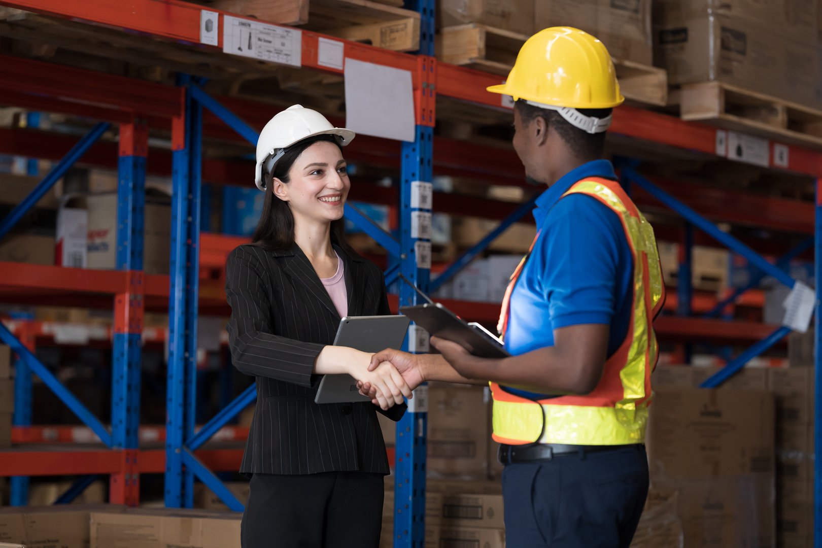 Warehouse concept. Worker, Male and female worker at warehouse, Storage, Check stock. Group of warehouse worker successful at work and shaking hands together. Unity and teamwork concept