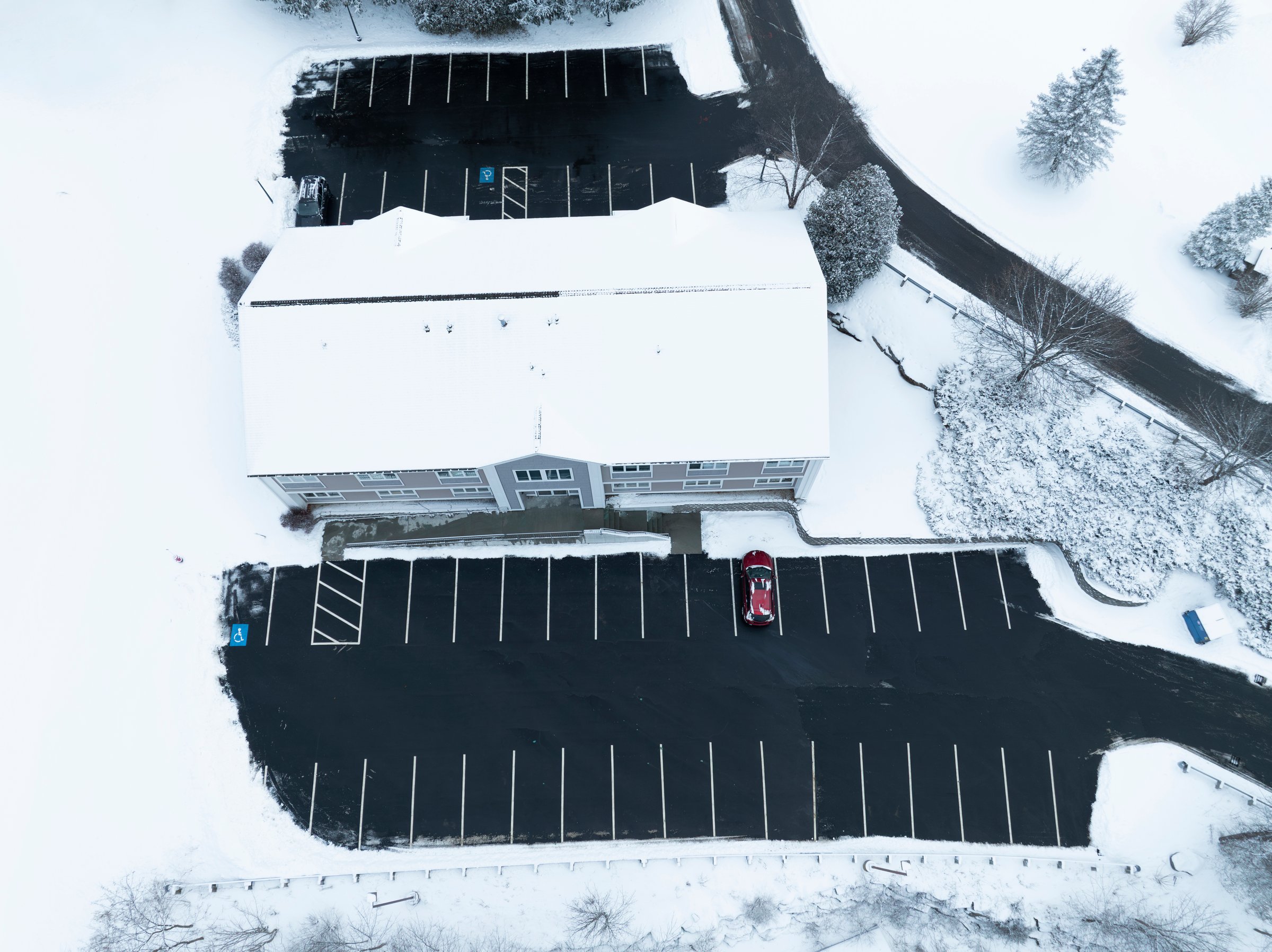 high angle view of building parking area with snow removed