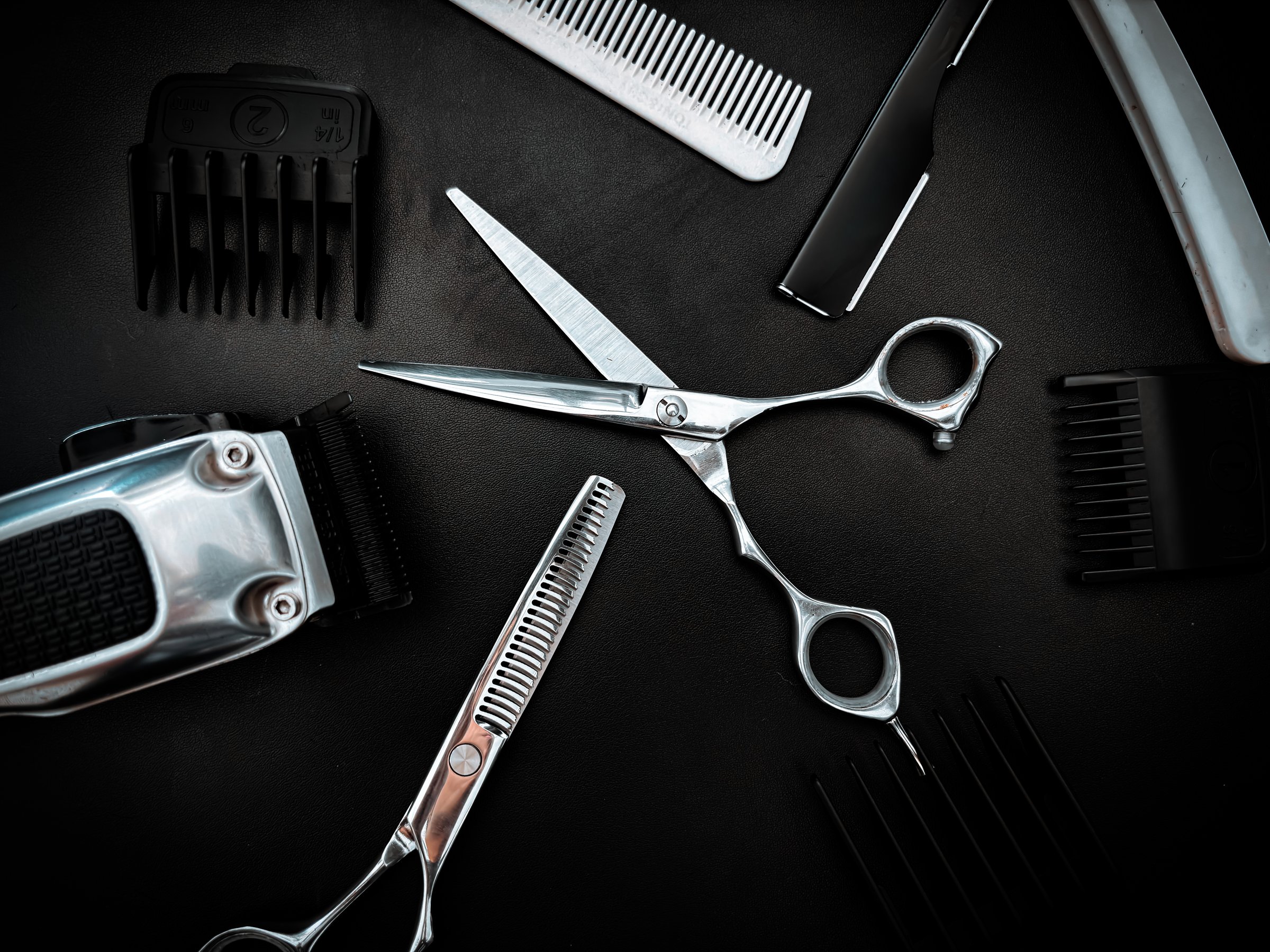 Professional Barber gear displayed on a dark matte surface