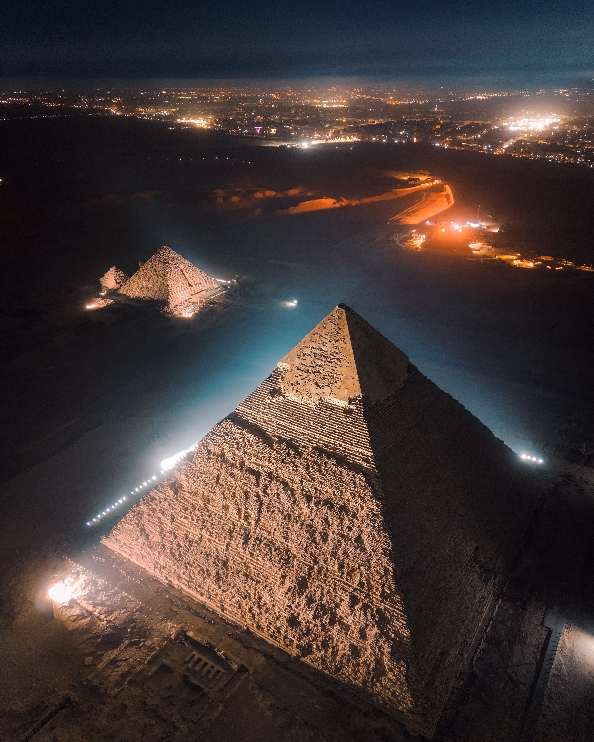 A nighttime scene of the Giza Pyramids