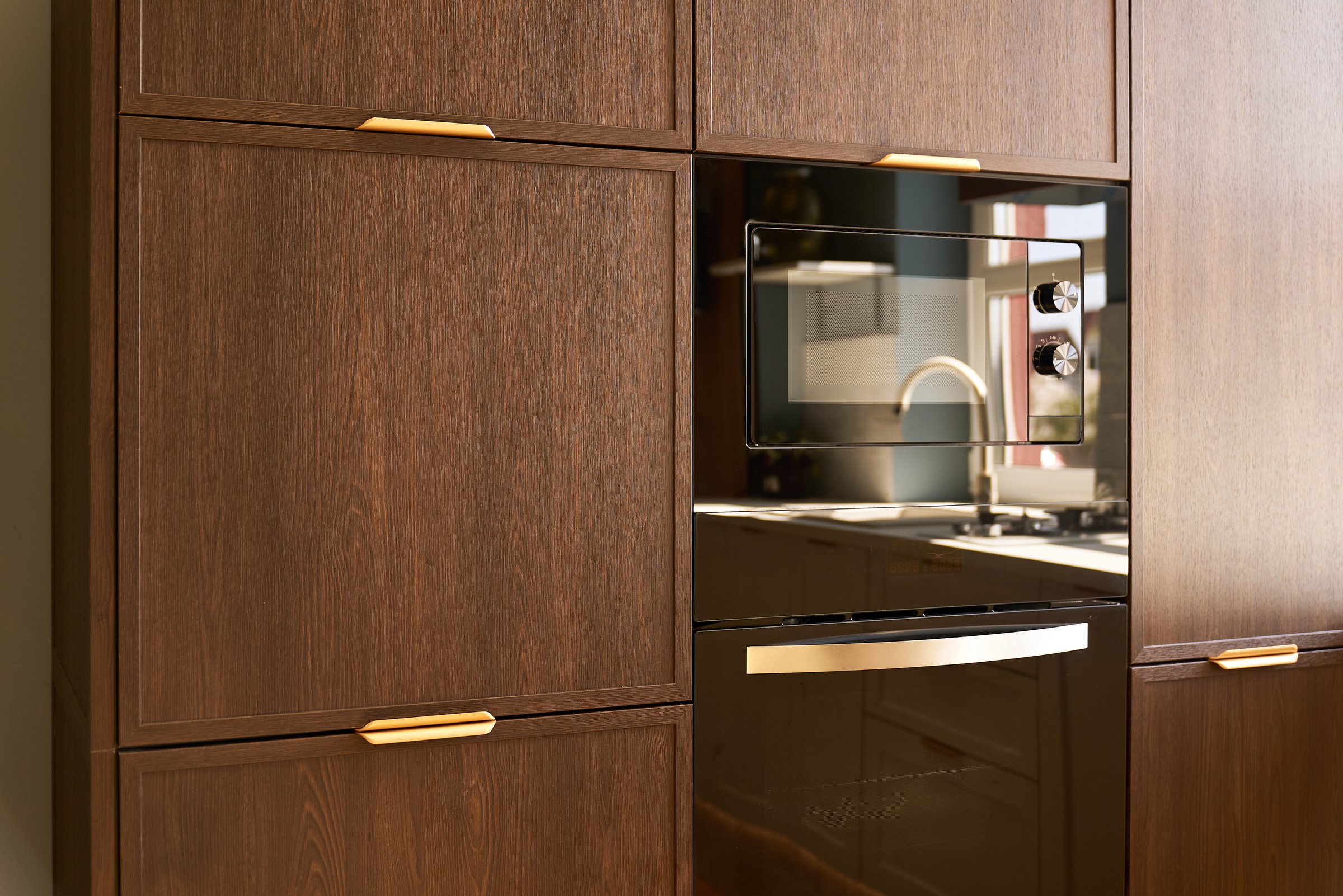 Modern kitchen with sleek microwave and stylish wooden cabinetry