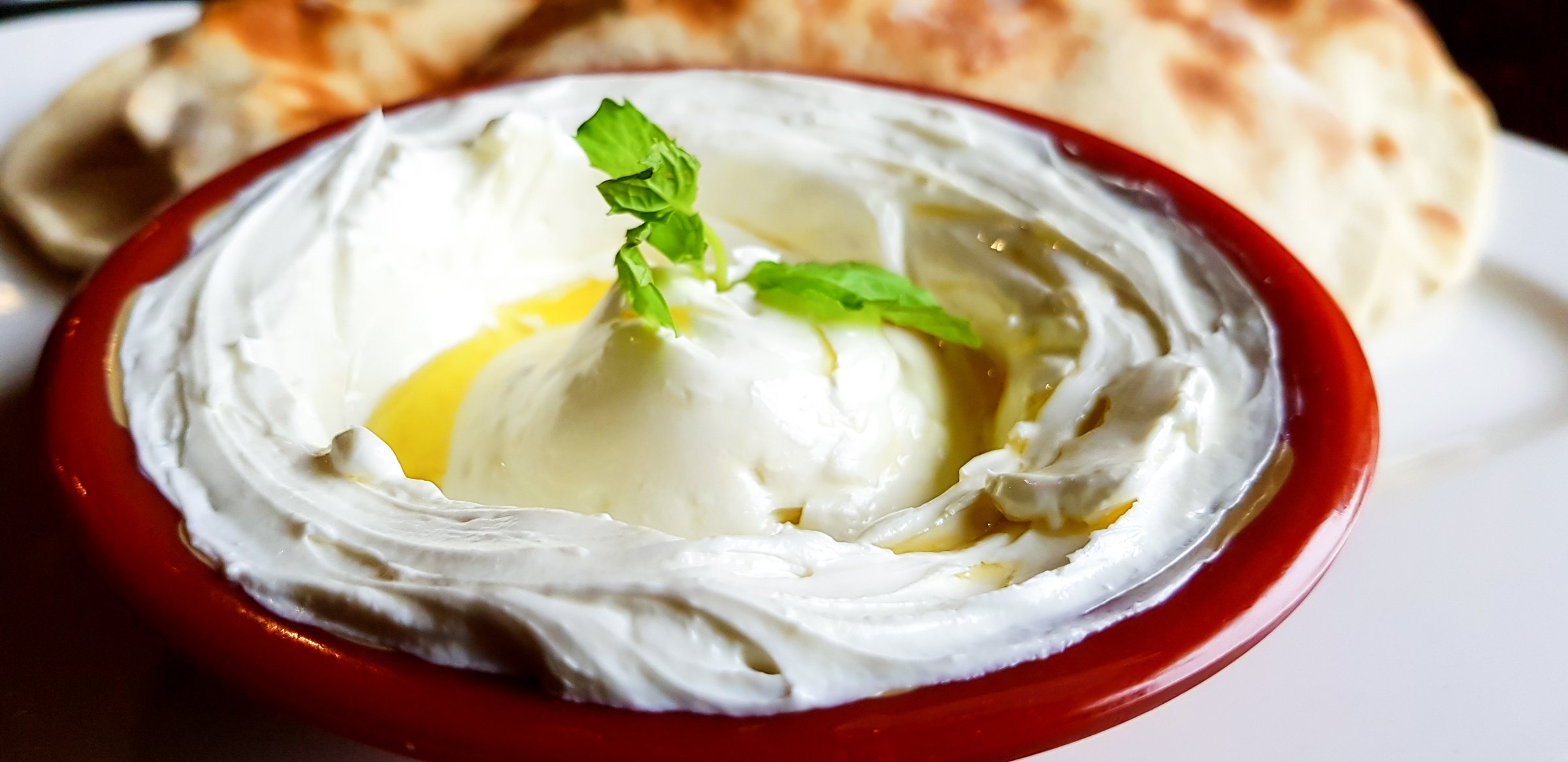 A bowl of labneh, a traditional Arab delicacy; A yoghurt cream cheese dip which is eaten with bread, it is very similar to Greek yogurt.