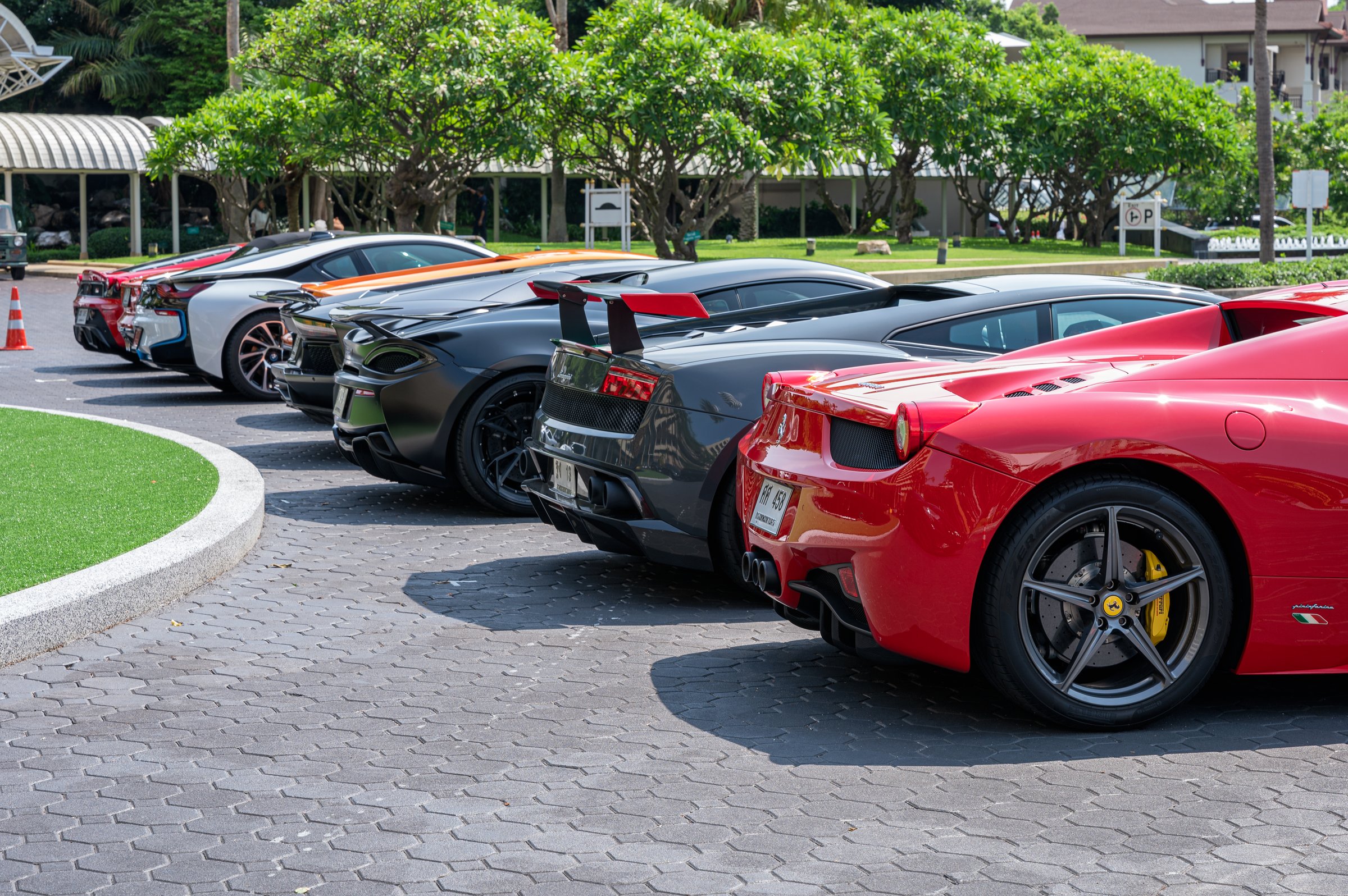 Pattaya, Thailand - May 26 2019 : Rear of sport cars with variety of famous brands parking on front of the Royal Cliff Beach Hotel