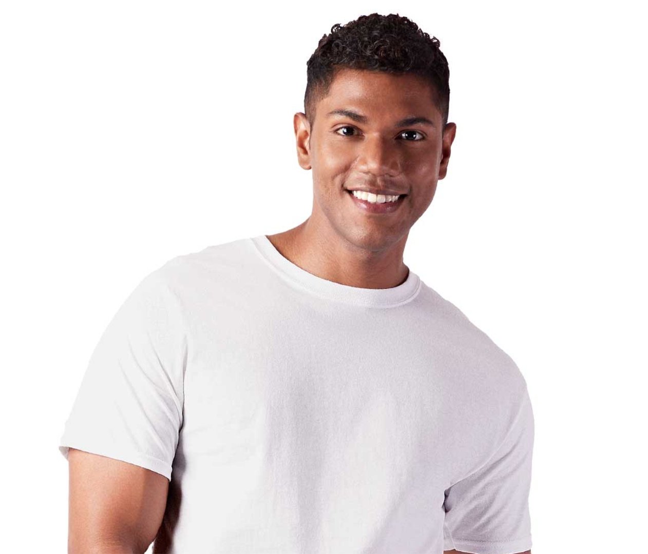 Young man in a white T-shirt smiling at camera, standing against a plain white background.
