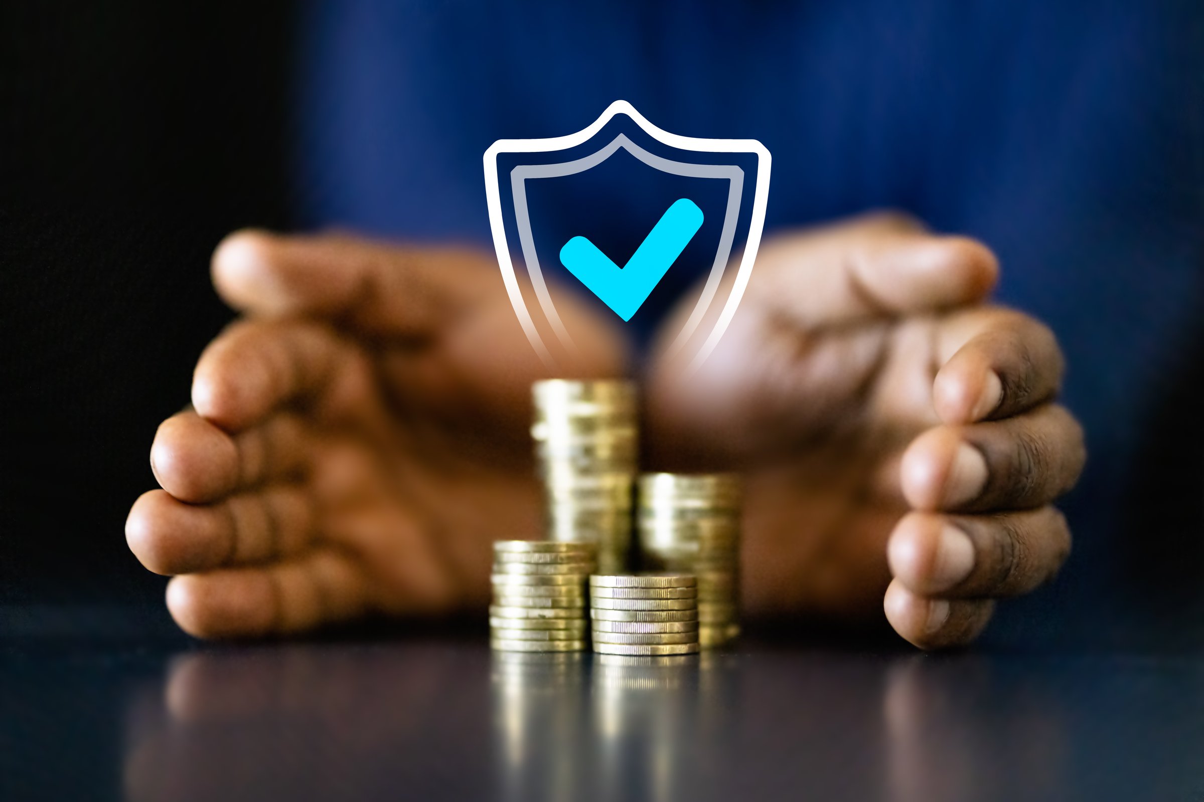 African American businessman counting coins to protect income and invest in long-term success. Professional finance manager securing his capital.