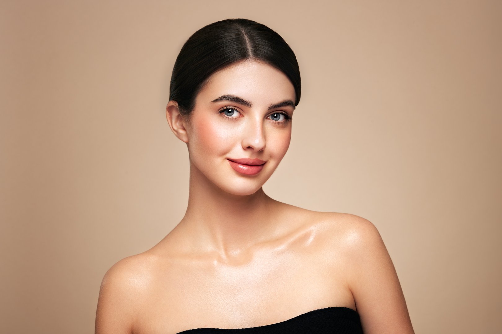 Portrait beautiful young woman with clean fresh skin. Model with healthy skin looks at an empty space, close up portrait. Cosmetology, beauty and spa