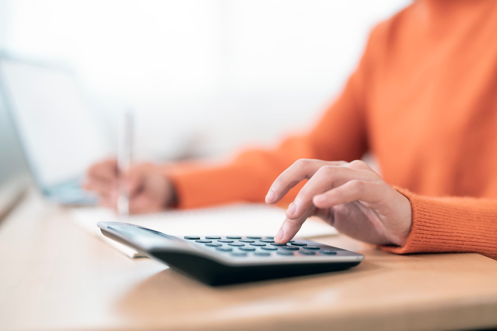 Close up woman hand using calculator. Doing finance, budgeting and tax calculation, monthly expenses