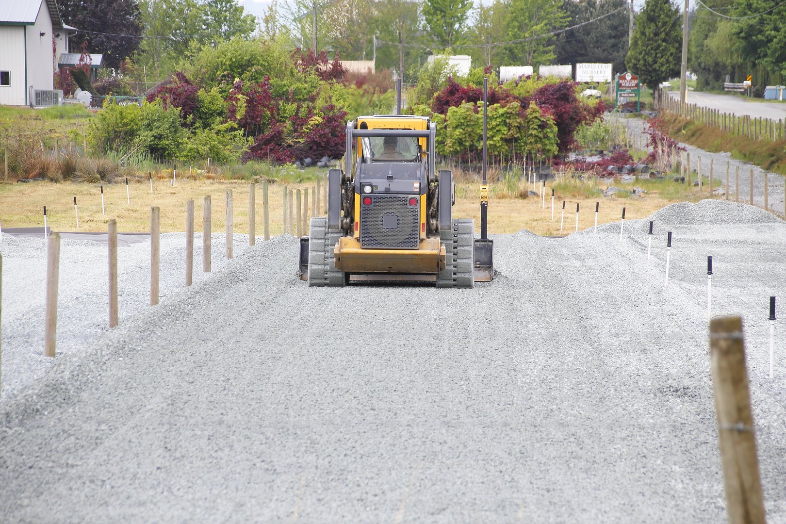 An industrial shovel and gravel is used to level a large area of ground. 