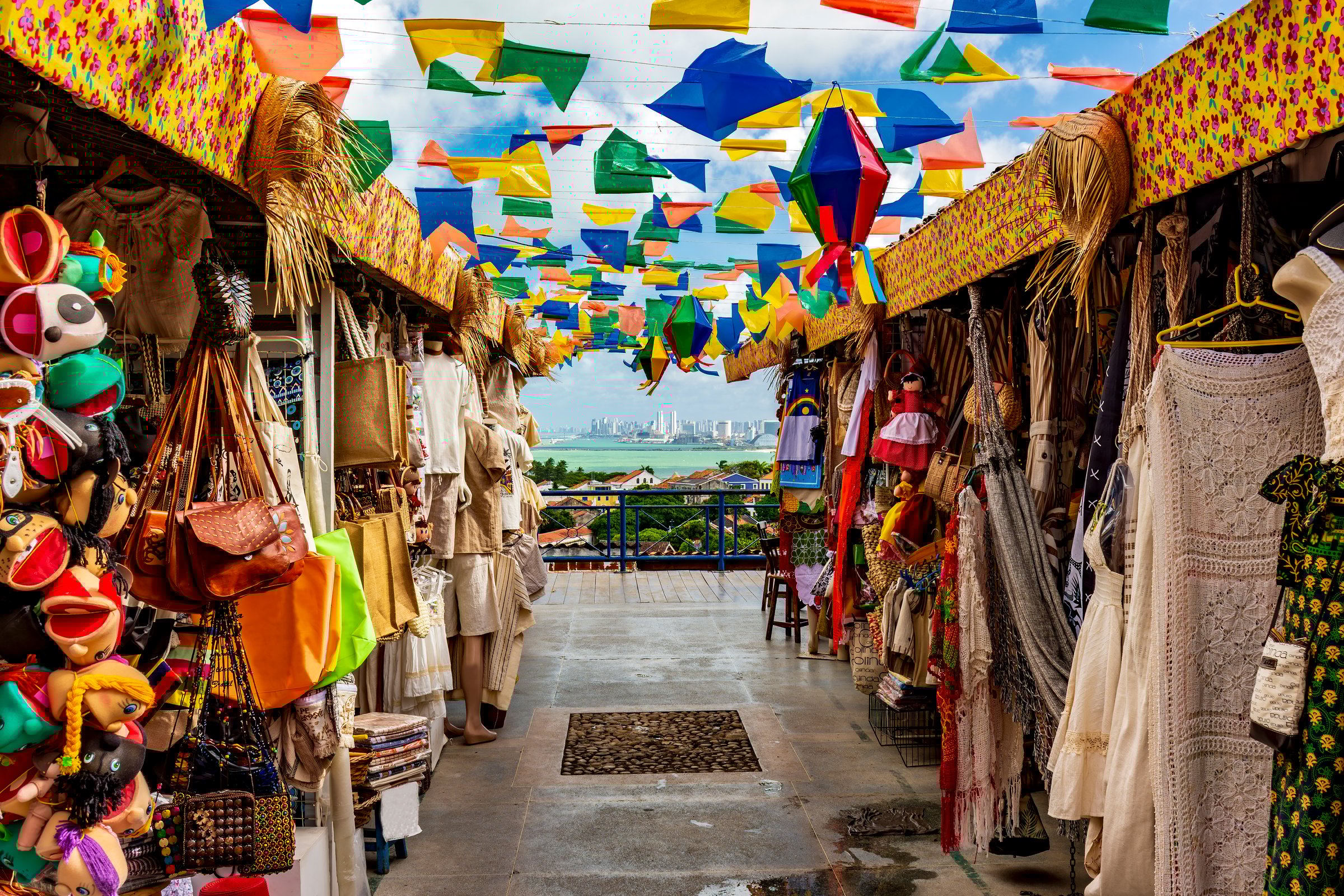 Brazilian street with shops for tourists in Olinda with a view of the city of Recife in the background