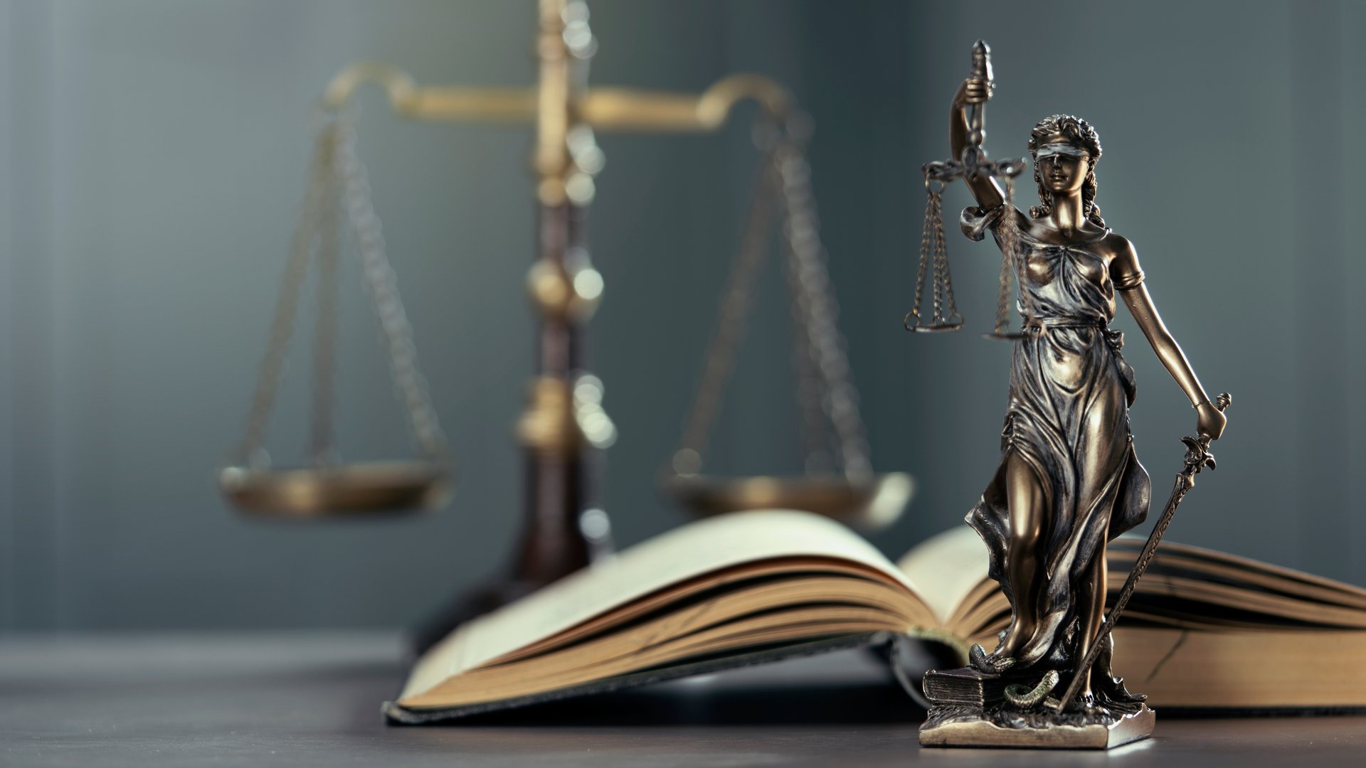 Law concept statue of Lady Justice on the table with book and scale