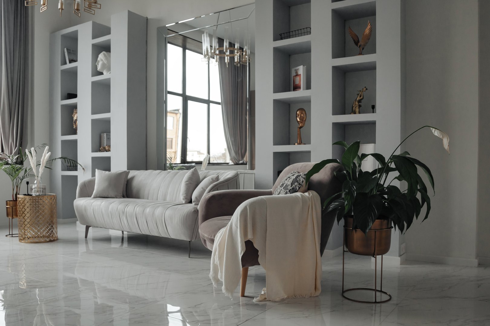 Modern interior of home living room with designer furniture with sofa, mirror, shelves, armchair and elegant personal accessories. Stylish neutral home decor. Design style concept. Copy ad text space