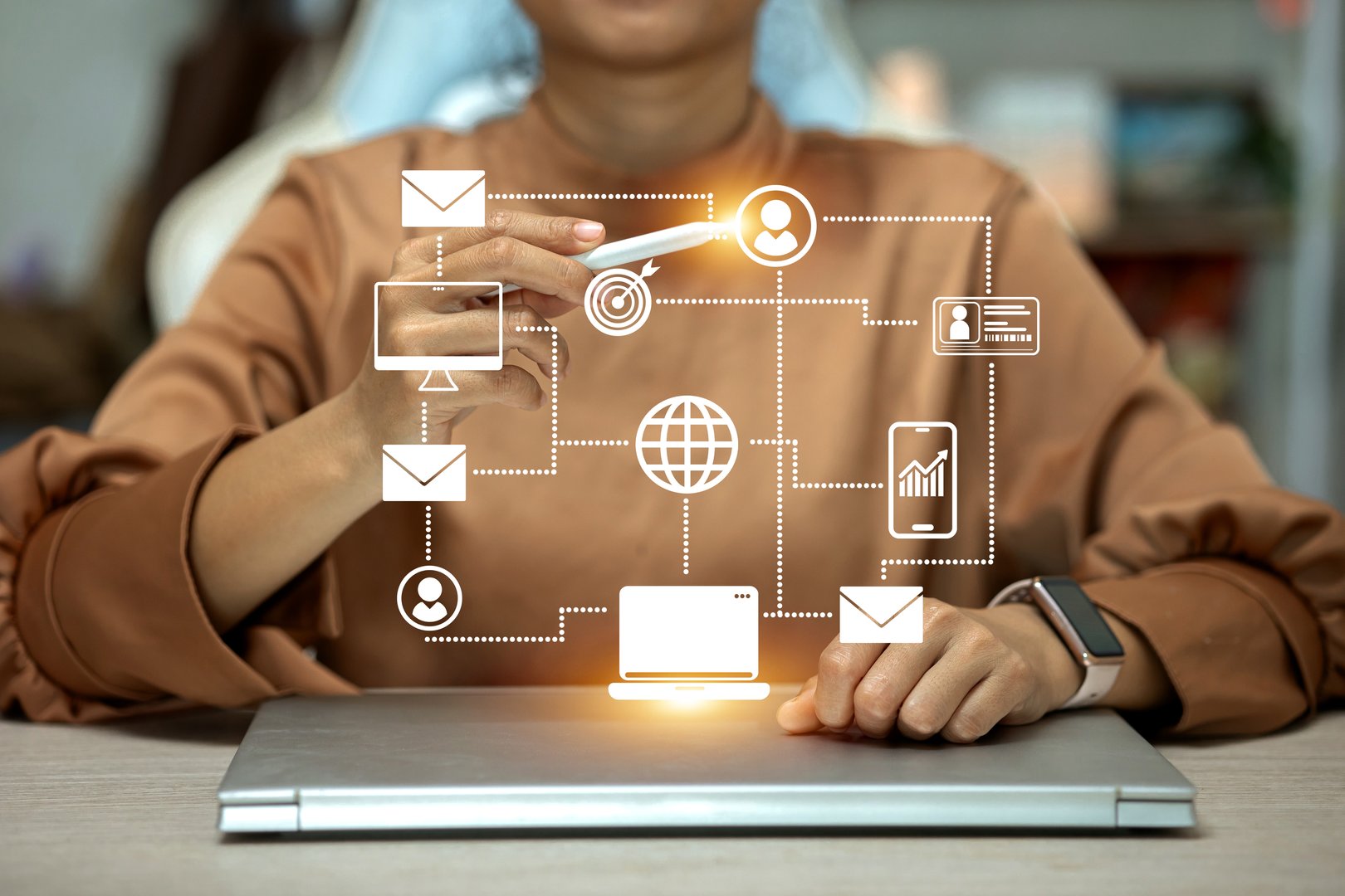 A person is drawing a network diagram on a laptop. The diagram includes a laptop, a mobile phone, a tablet, and a computer monitor.