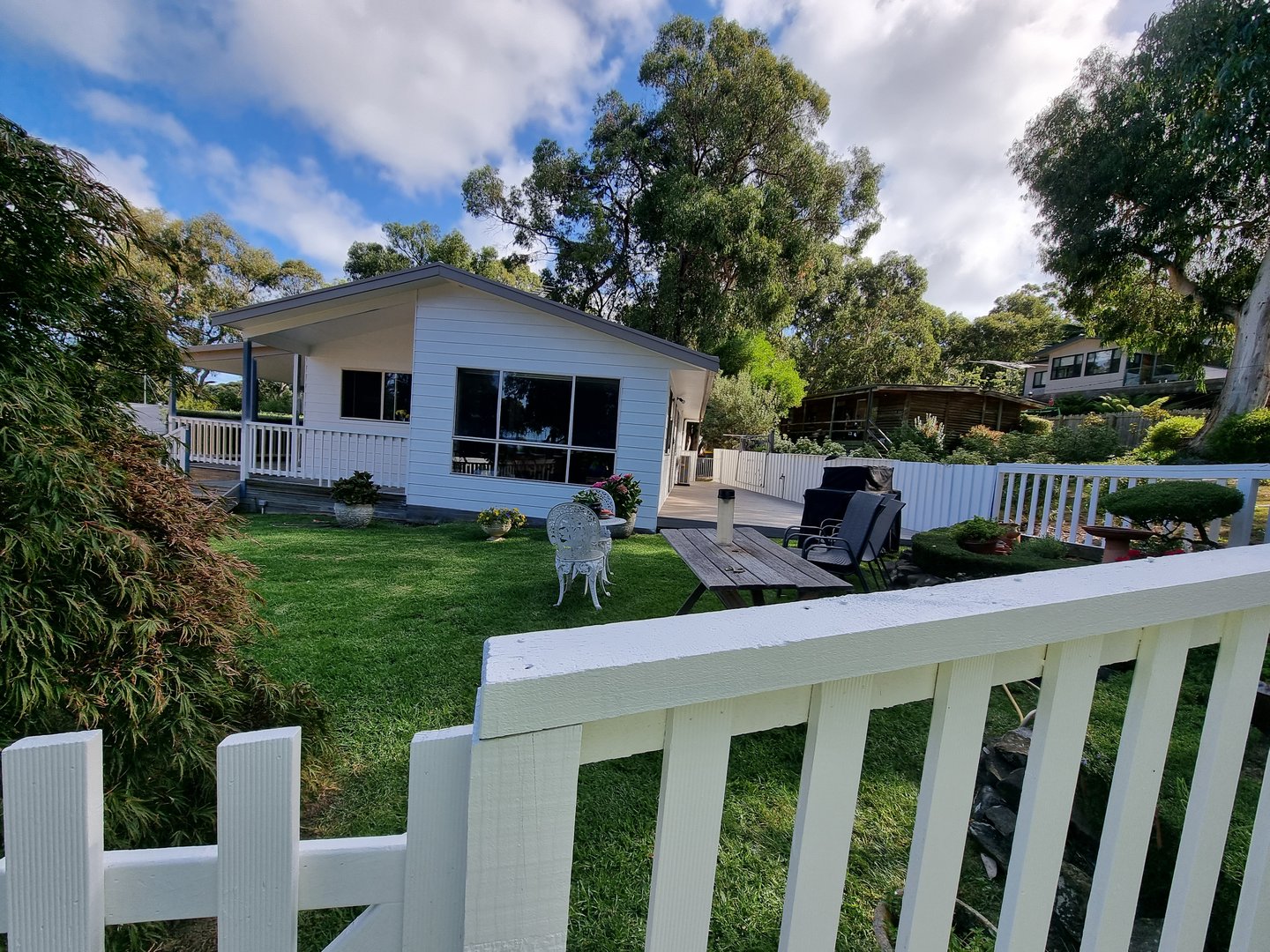 Coastal cottage exterior painting project completed by Quality Painting Group