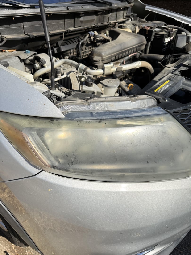 Before headlight restoration - Nissan cloudy headlights