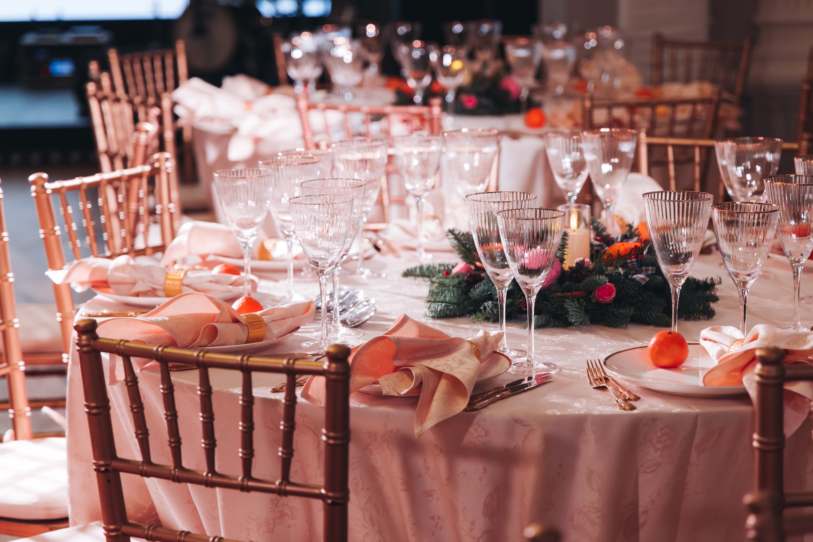 Beautiful table decoration for luxury  event in pink and gold, cutlery and tableware, banquet hall arrangement decor, celebration in restaurant with flowers, candles on a wedding reception party
