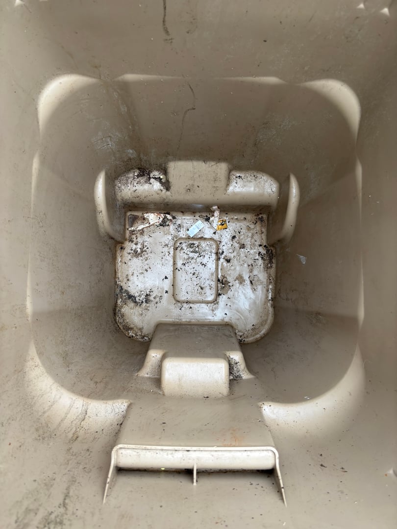 Dirty trash bin before cleaning