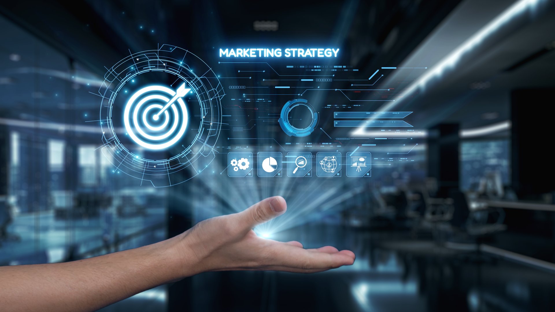 A creative representation of a marketing strategy concept featuring a hand supporting a target icon. The image highlights technological advancements in a modern office space. Auvana