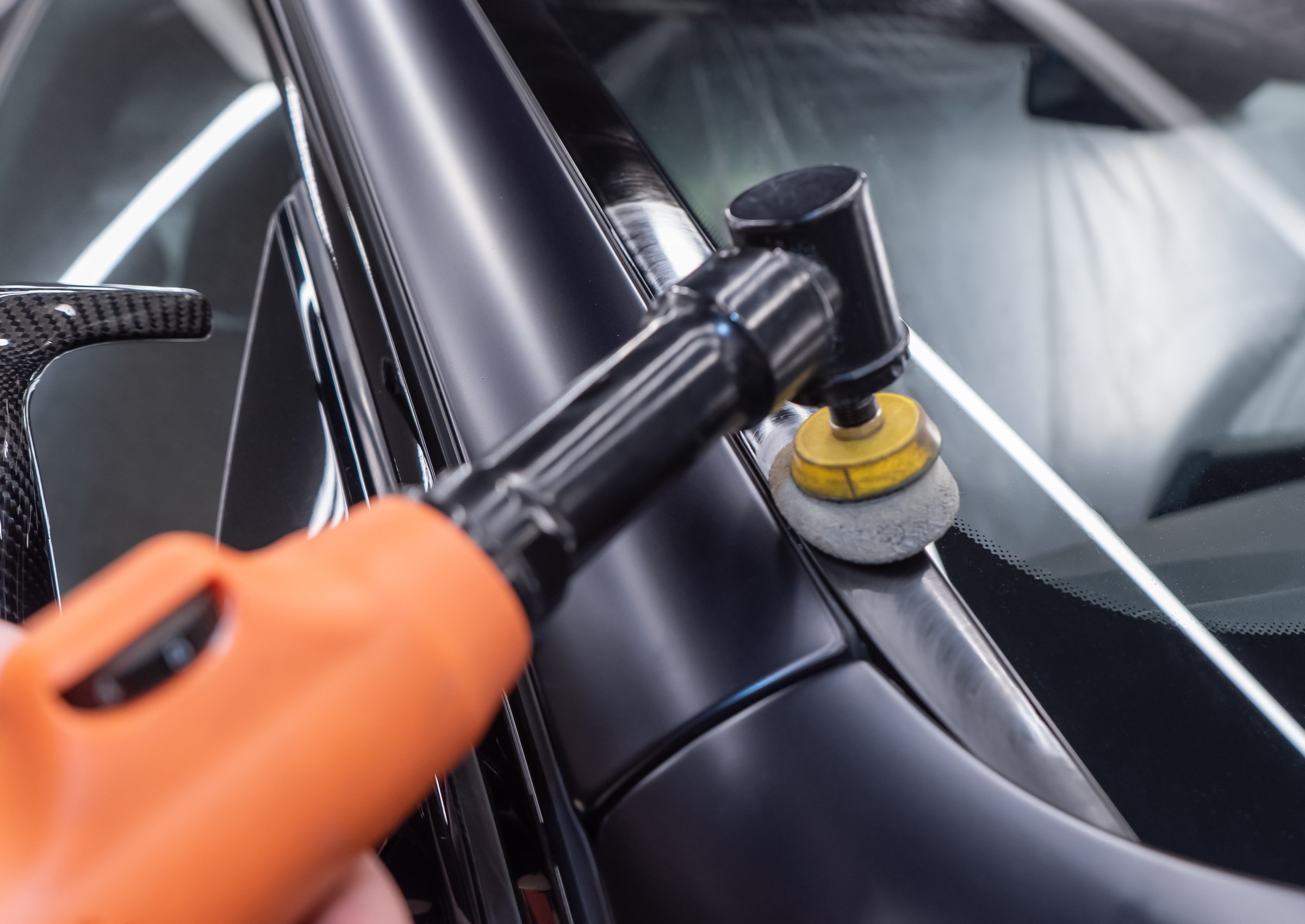 Car detailing - polishing car body close-up