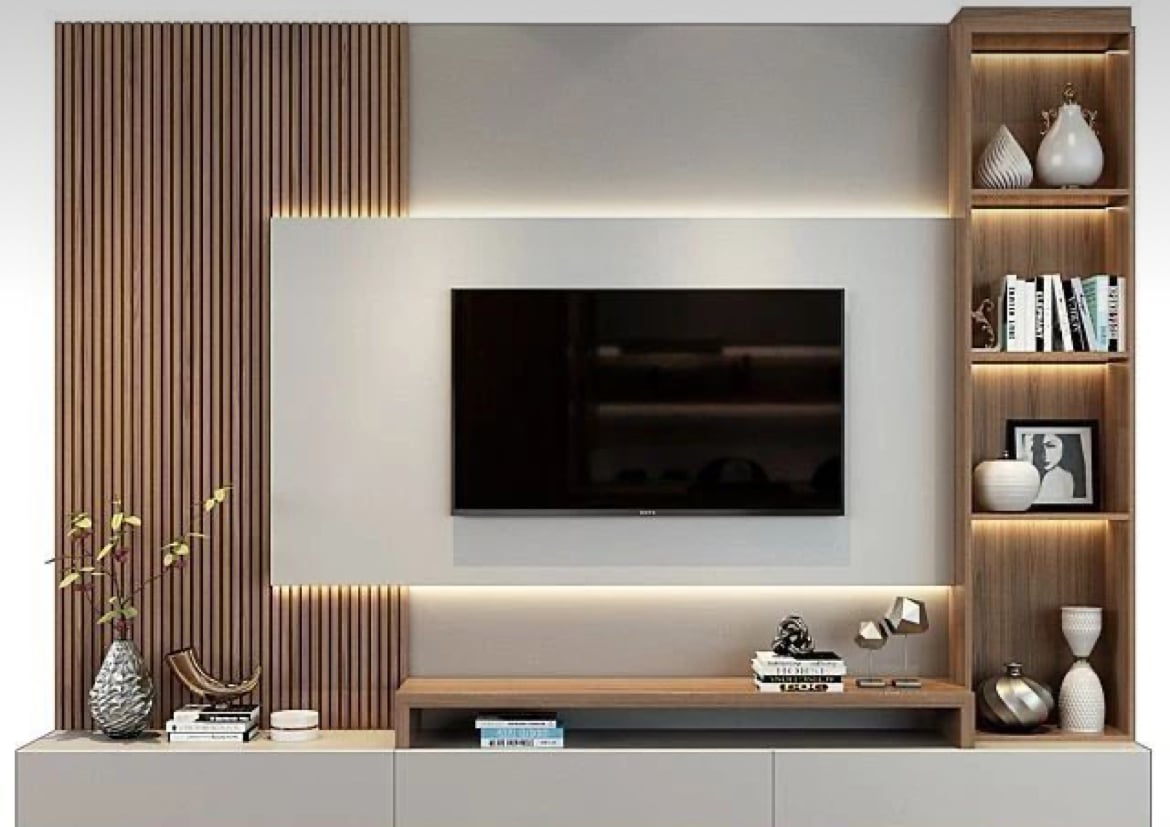 Modern living room with a wall-mounted TV, wooden shelves, decorative items, and ambient lighting.
