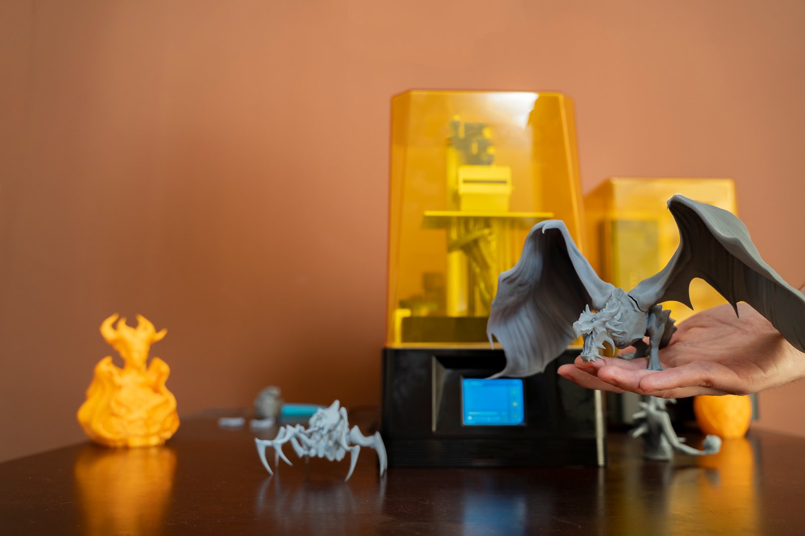 3D printer and printed figurines on tabl e